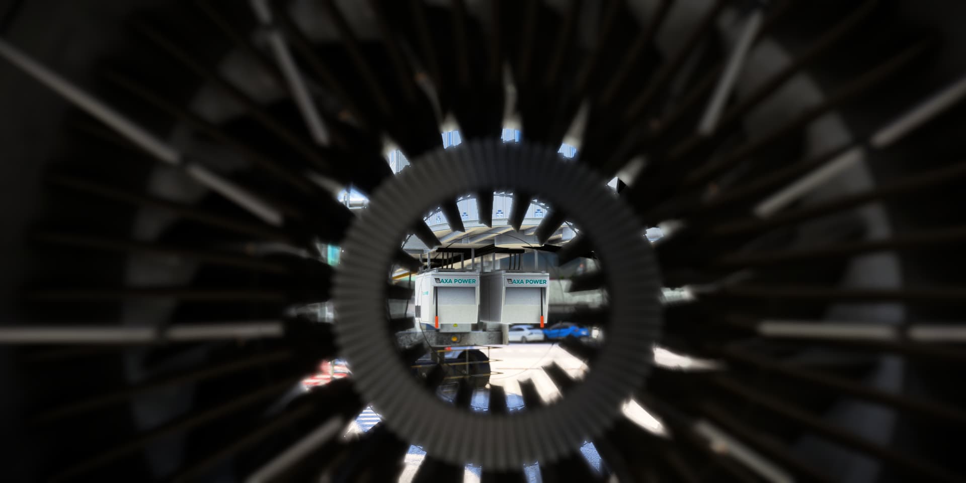 A view from inside the engine of an Airbus A320 NEO facing forwards towards an airport terminal.