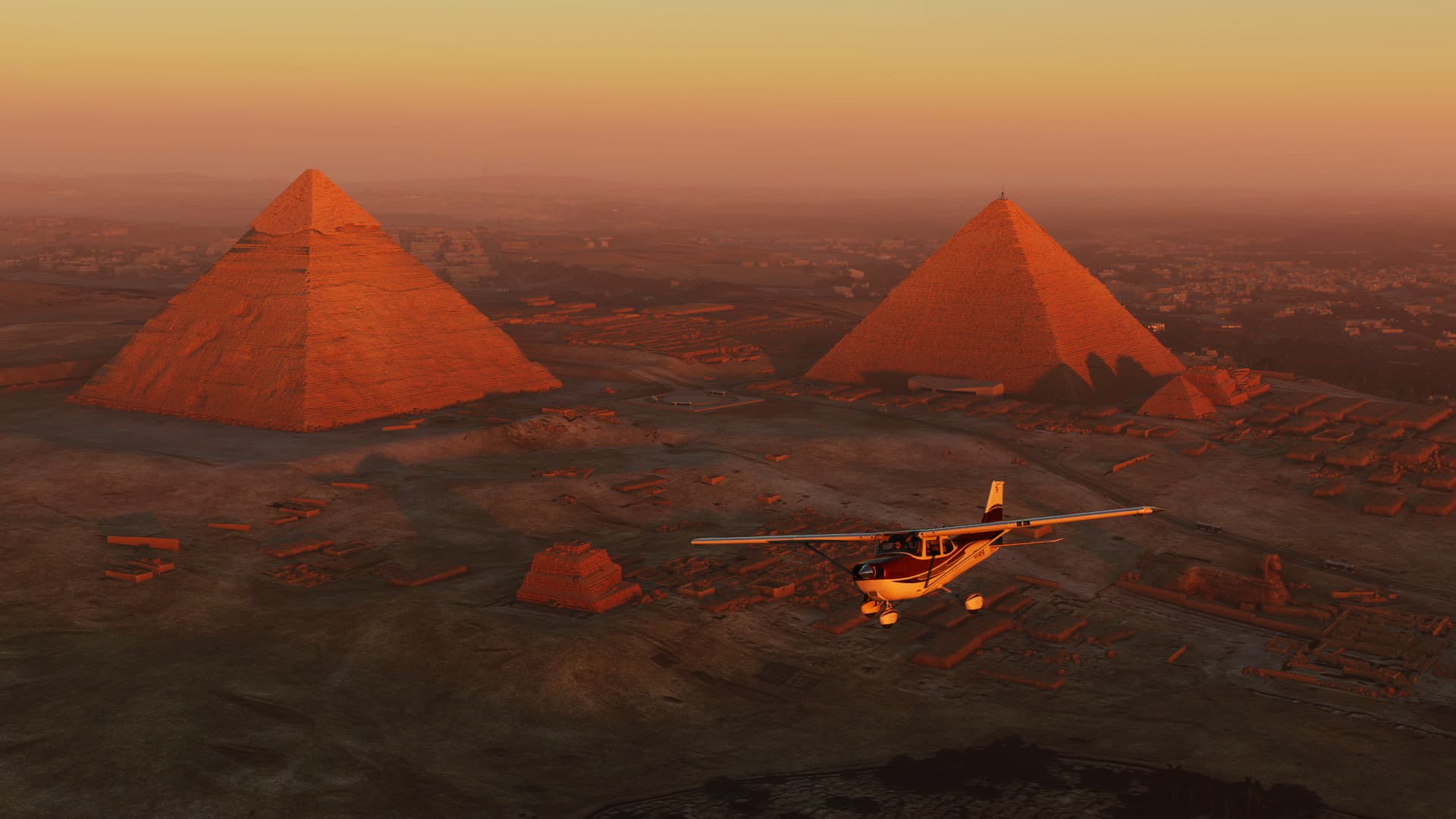 A Cessna 172 banks right over the Pyramids of Giza, Egypt at sunset