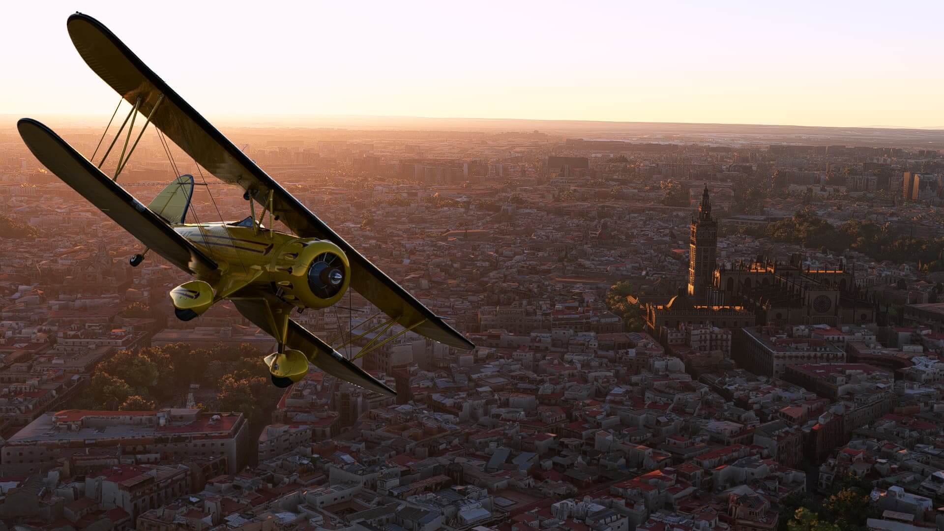 A yellow Pitt propeller aircraft banks left over a dense city, with a cathedral towering over houses below