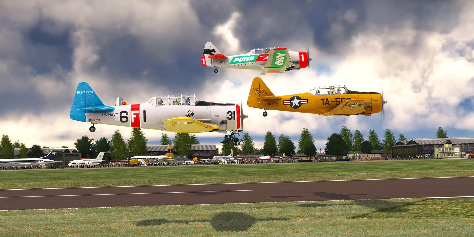 Three T-6 Texans fly in low formation close to a runway as they display at an airshow