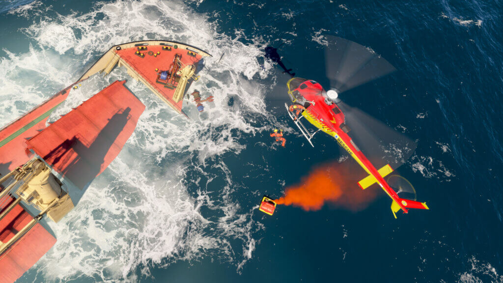 An H125 helicopter hovers above a sinking cargo ship, with medical personnel being winched down from the aircraft