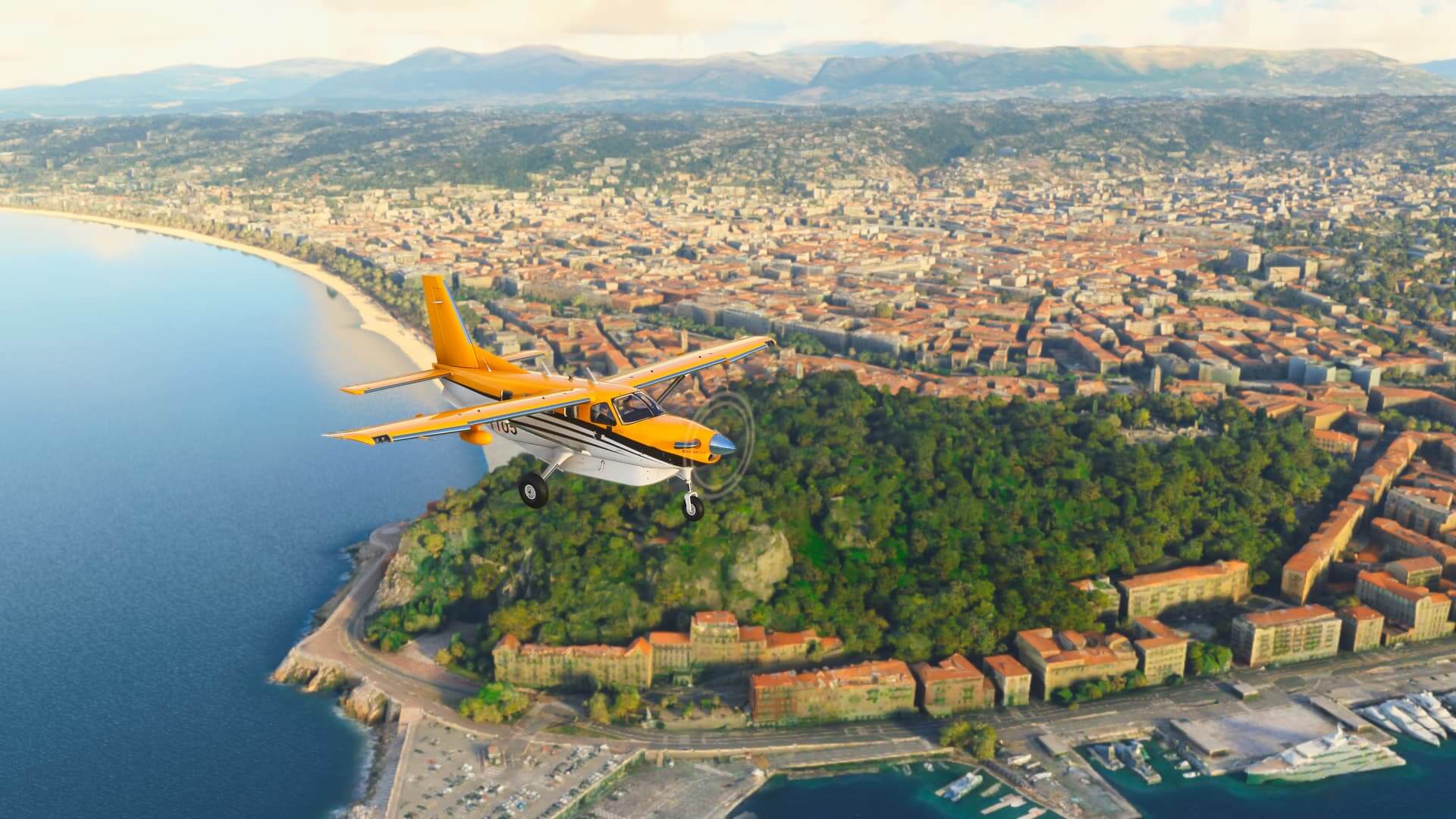 A yellow and white high wing propeller aircraft flies along the coast of Monaco