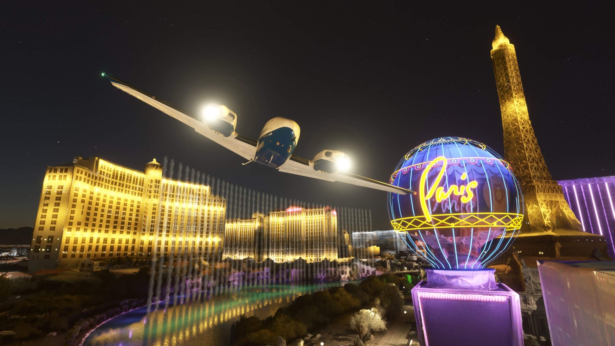 A low wing propeller aircraft flies through the Bellagio fountains on the Las Vegas strip during night