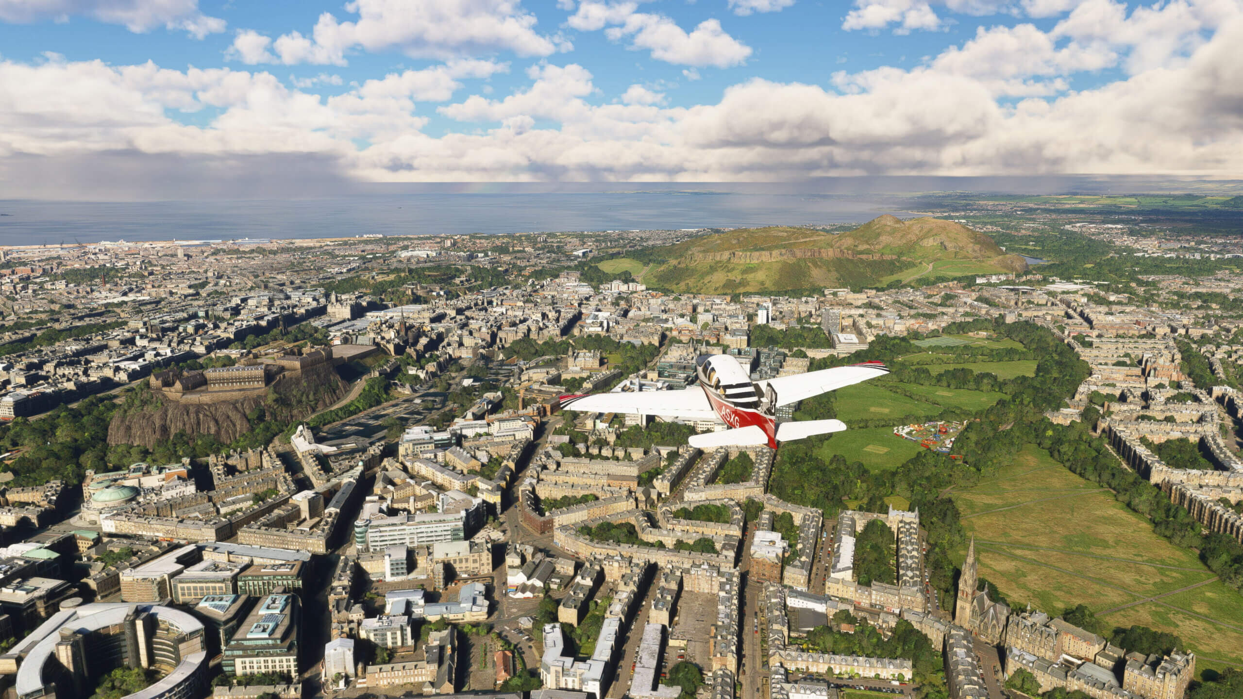 An aircraft flies over Edinburgh.