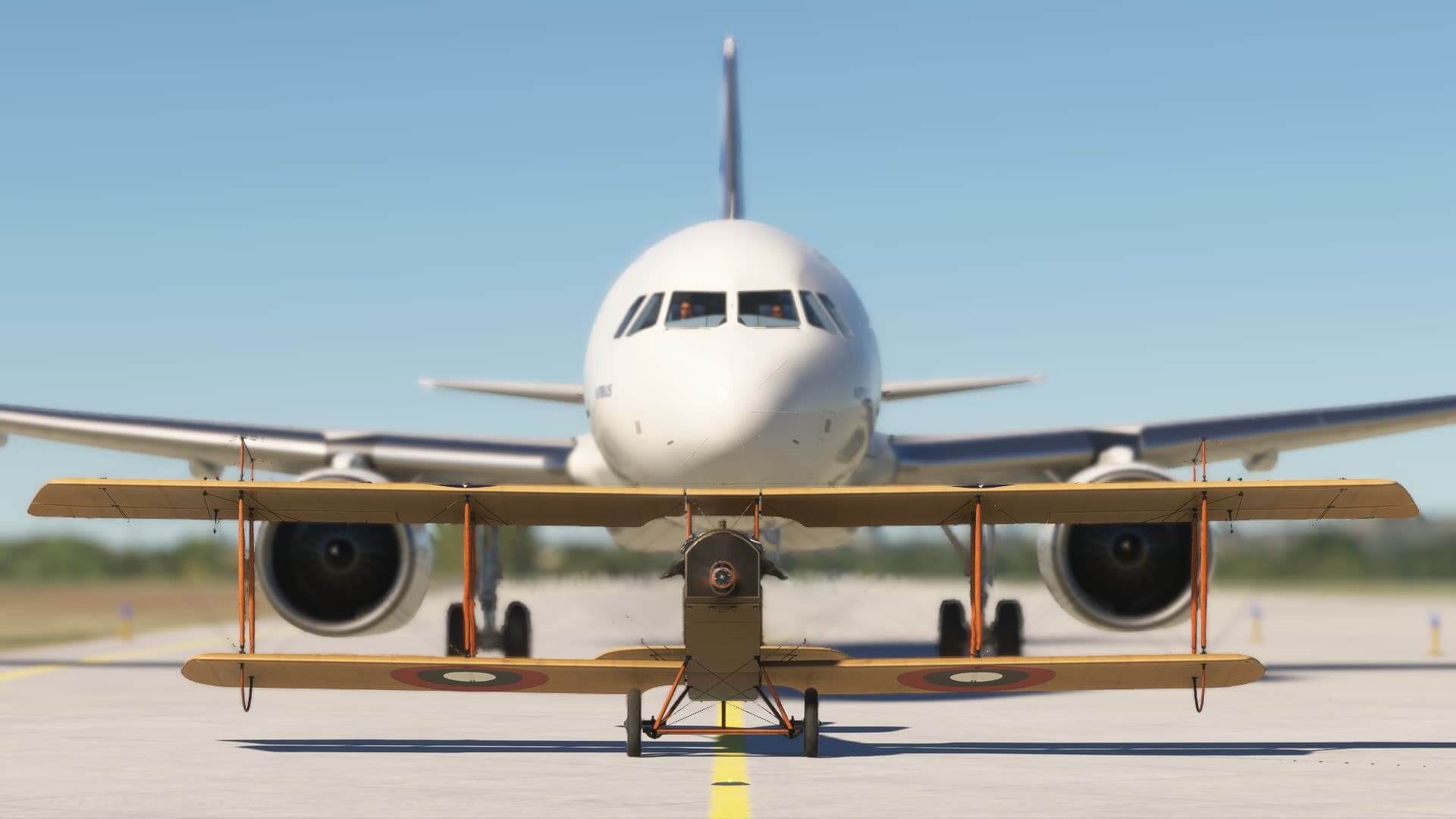 An Airbus A320 taxis behind a dual wing retro warbird