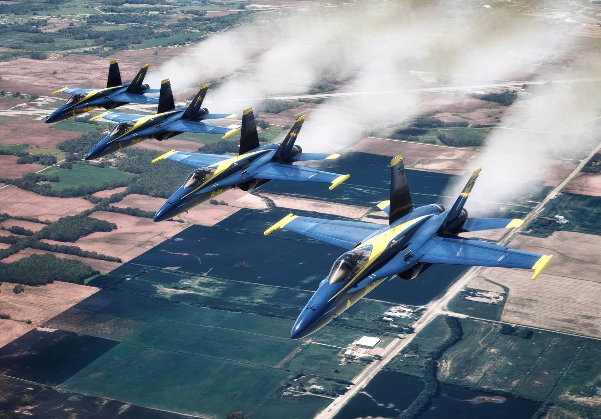 Four F-18's from The Blue Angels fly in formation with white smoke pluming from the tails