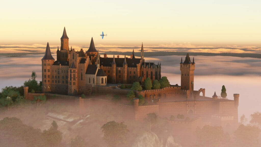 A blue low wing propeller aircraft banks left whilst flying past a castle