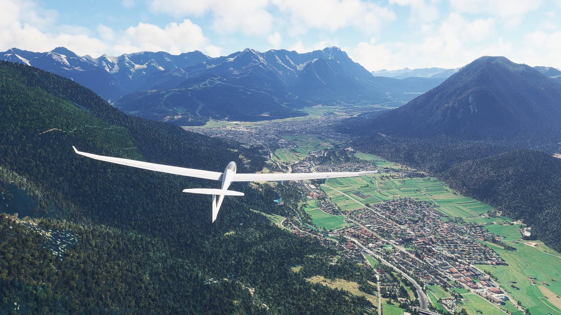 A glider flies above the Alps