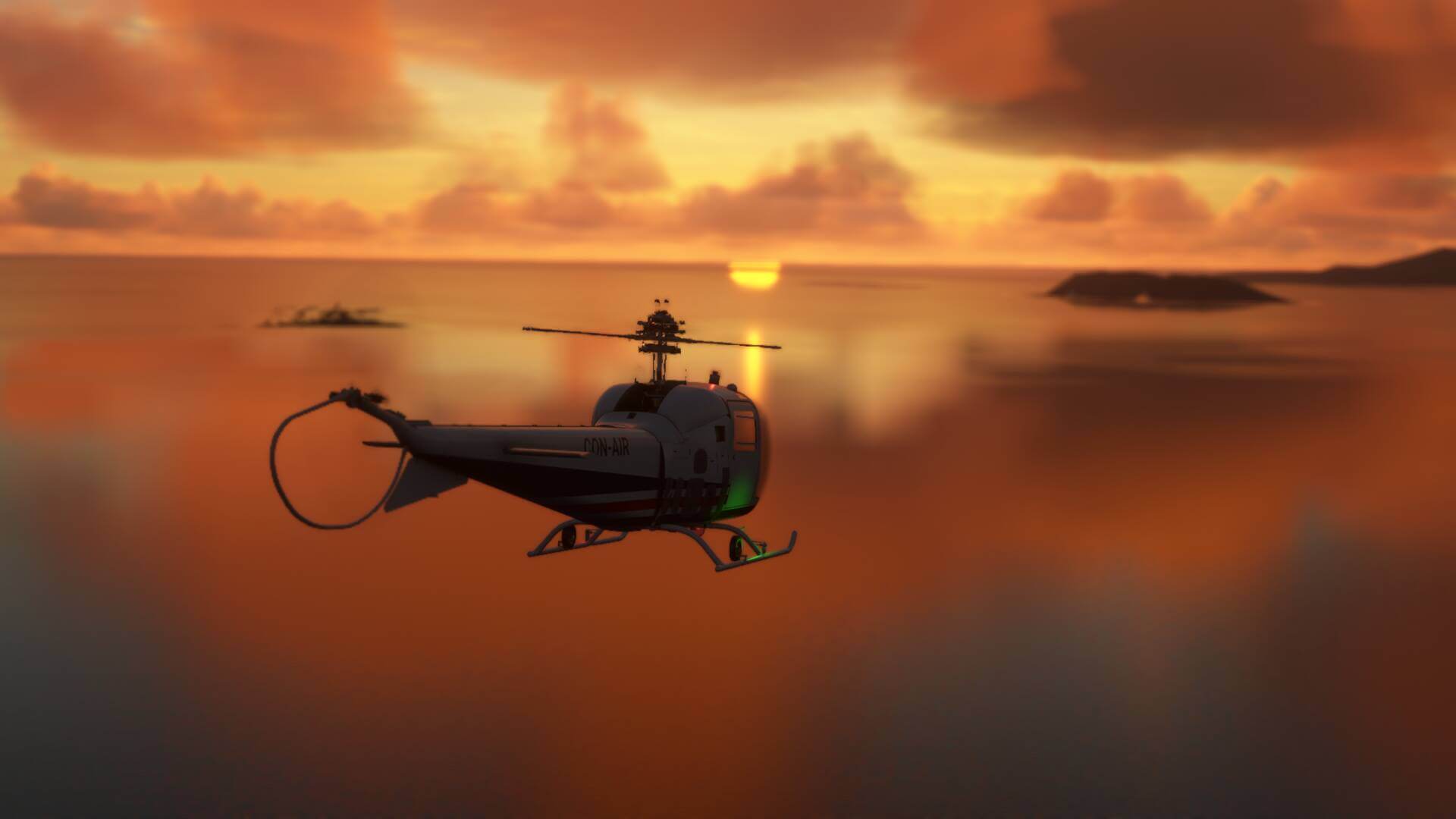 A Bell 47J Ranger flies over the ocean towards the setting sun