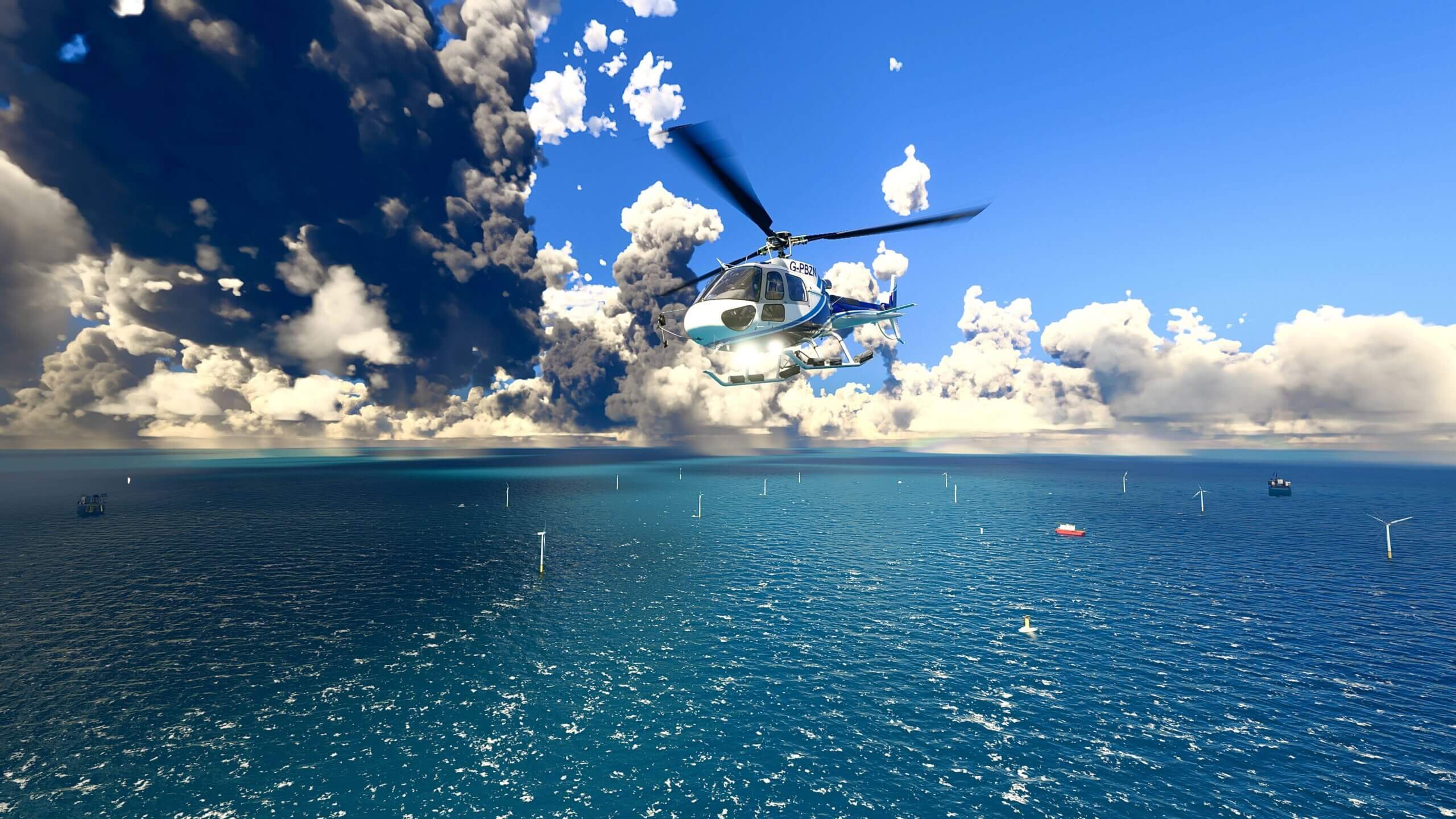 A helicopter flies over a blue ocean. There are several ships and wind turbines visible on the water surface.