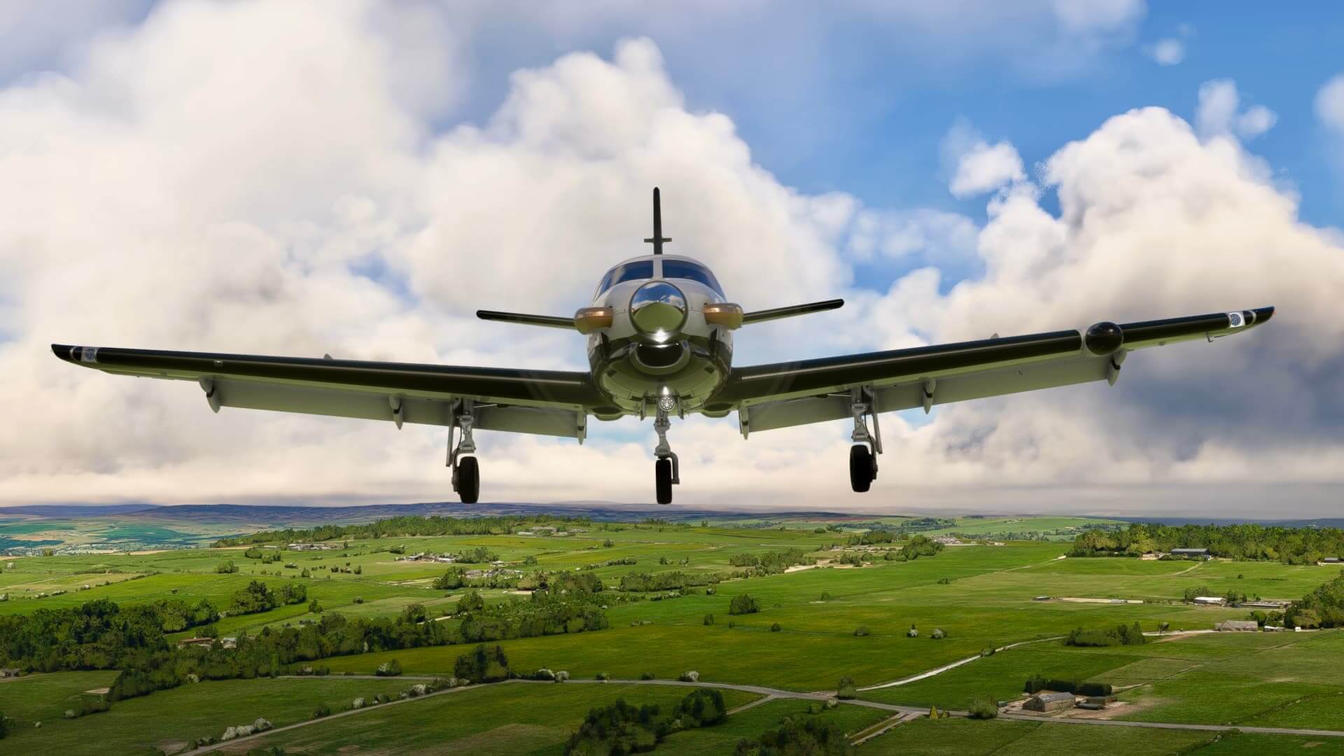 A Daher TBM flies over a green countryside