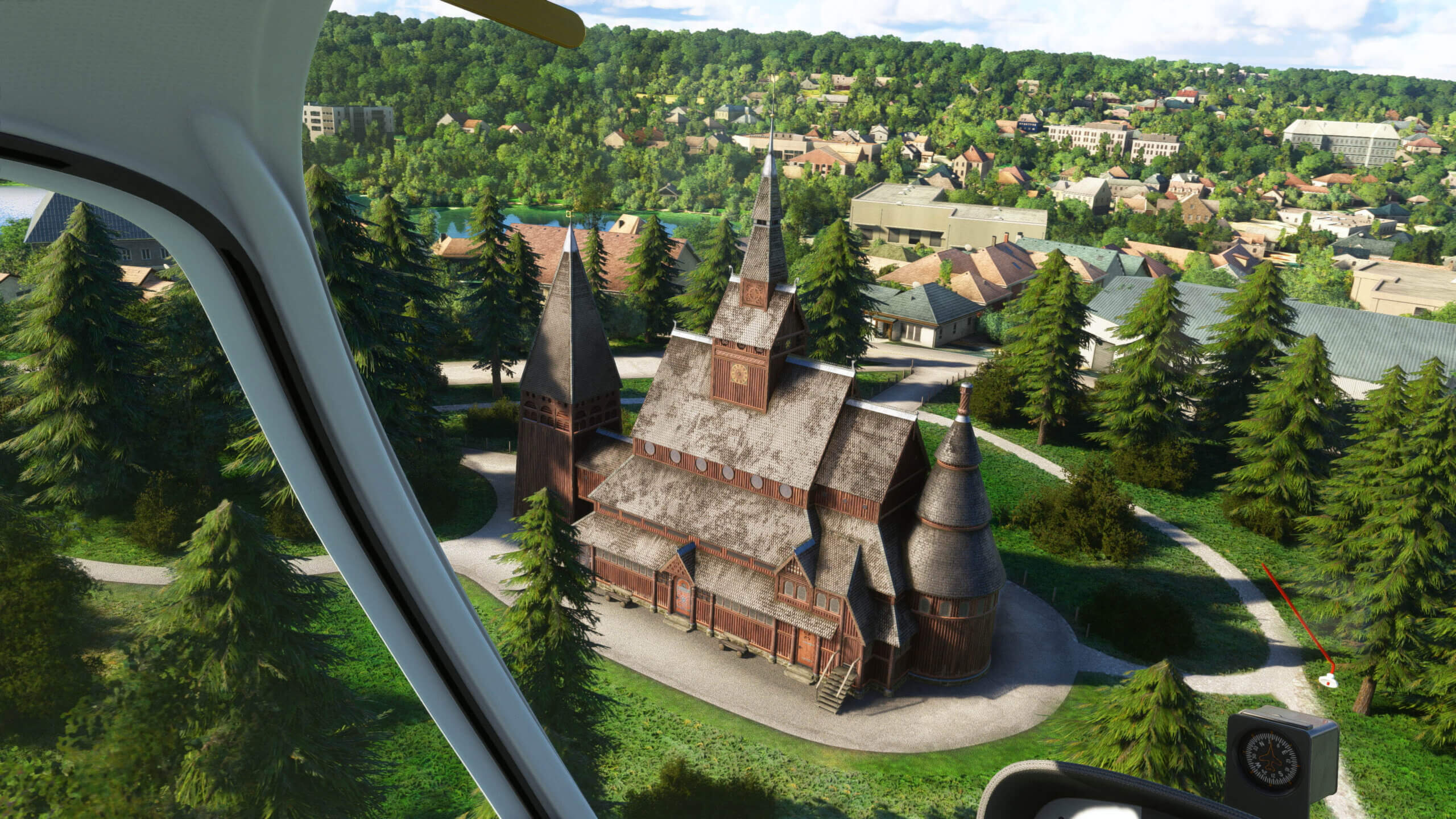 Interior cockpit view looking out over an old wooden church below