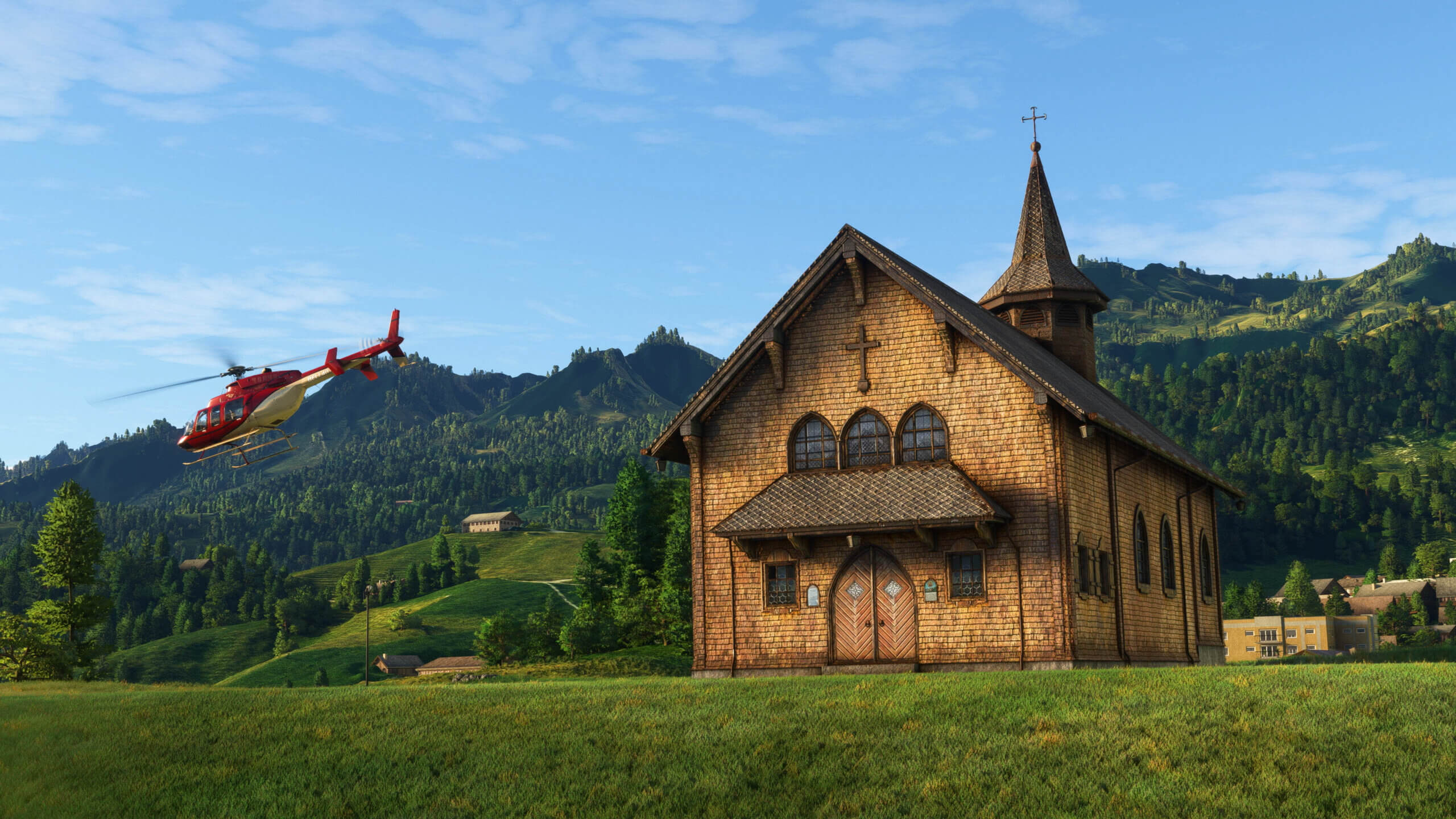 A Bell 407 helicopter takes off next to an old wooden church