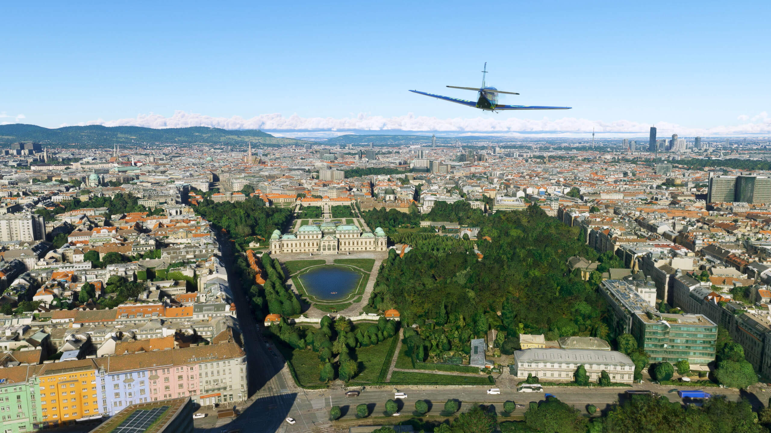 A Beechcraft Bonanza flies over a city.