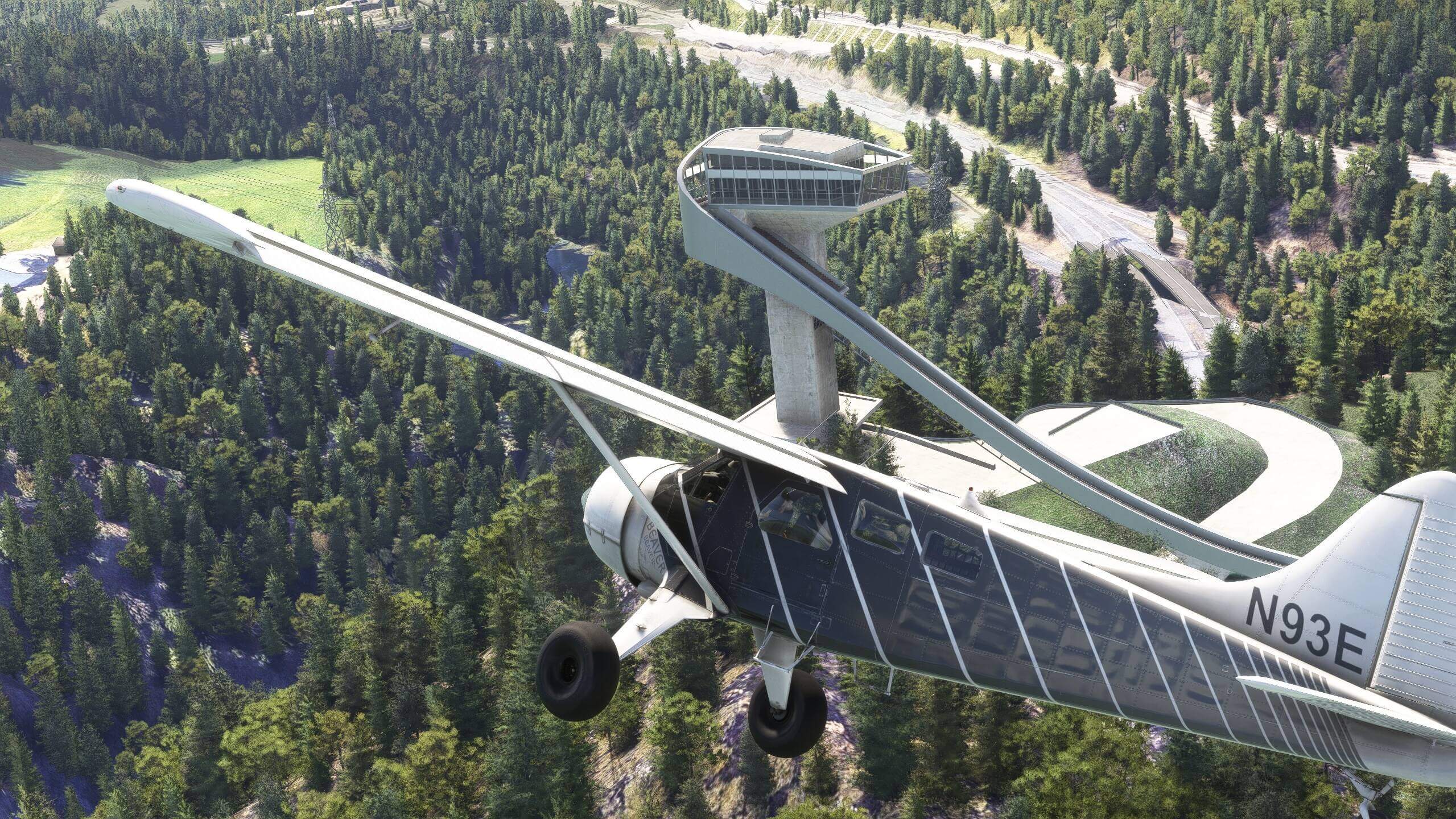 A high wing propeller aircraft passes a ski jump