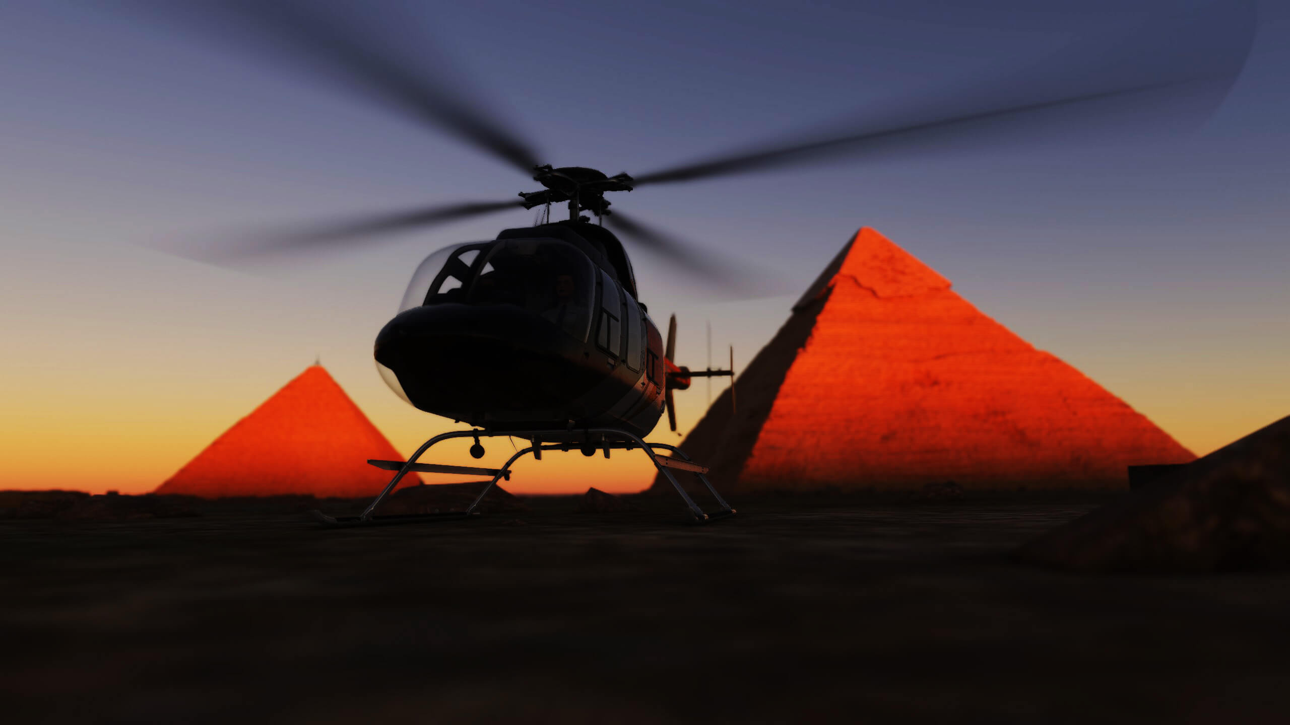 A Bell 407 helicopter landed next to the Great Pyramids of Giza