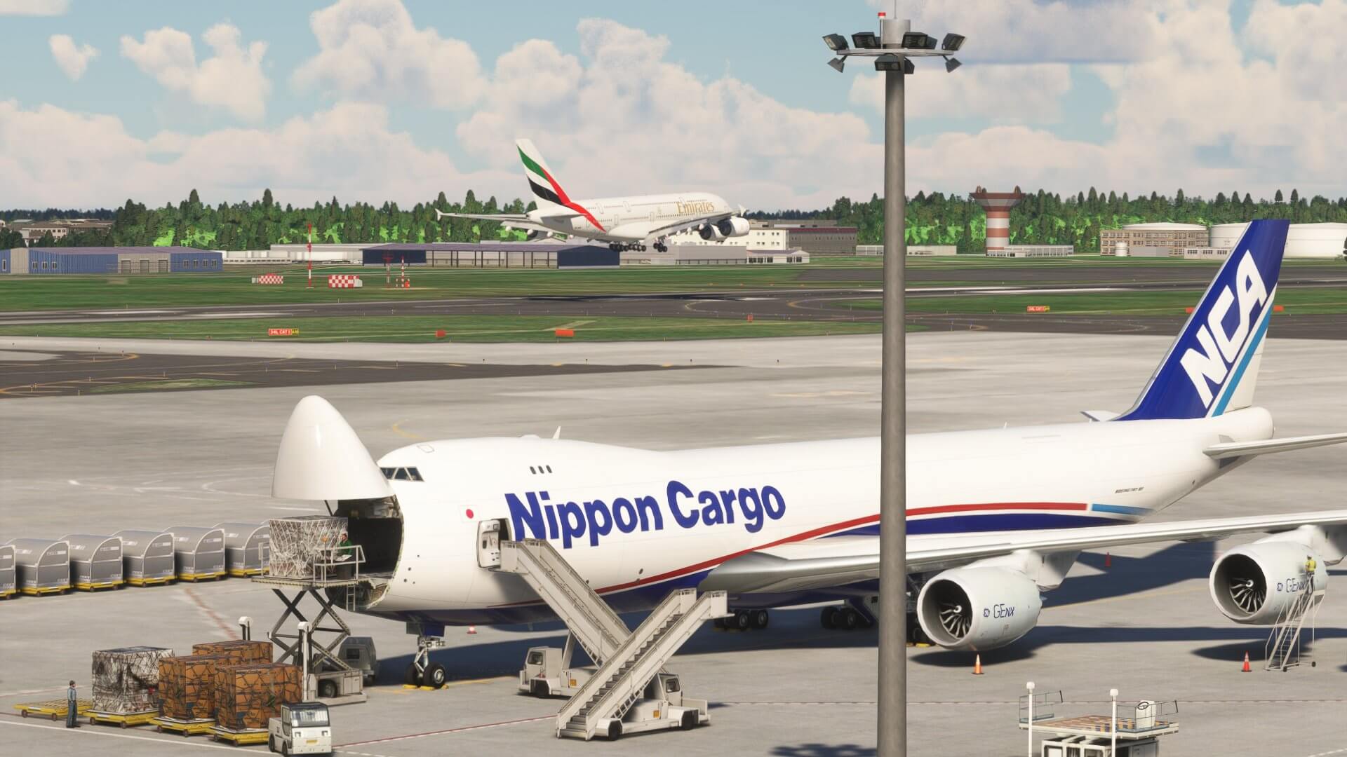 An Emirates A380 on short final to land whilst a Nippon Cargo Boeing 747-8 loads cargo on the apron