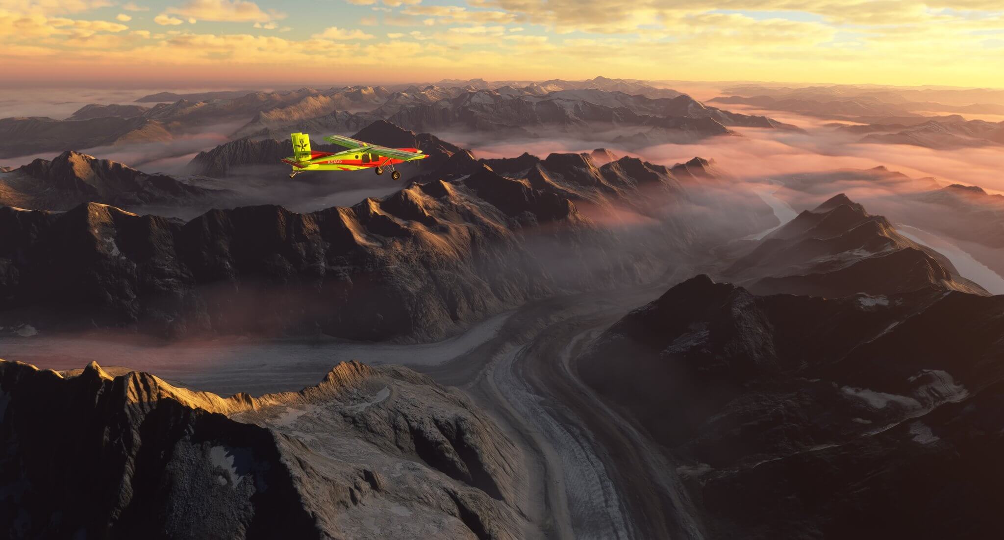 A red and yellow Pilatus PC-6 in level flight above mountain ranges