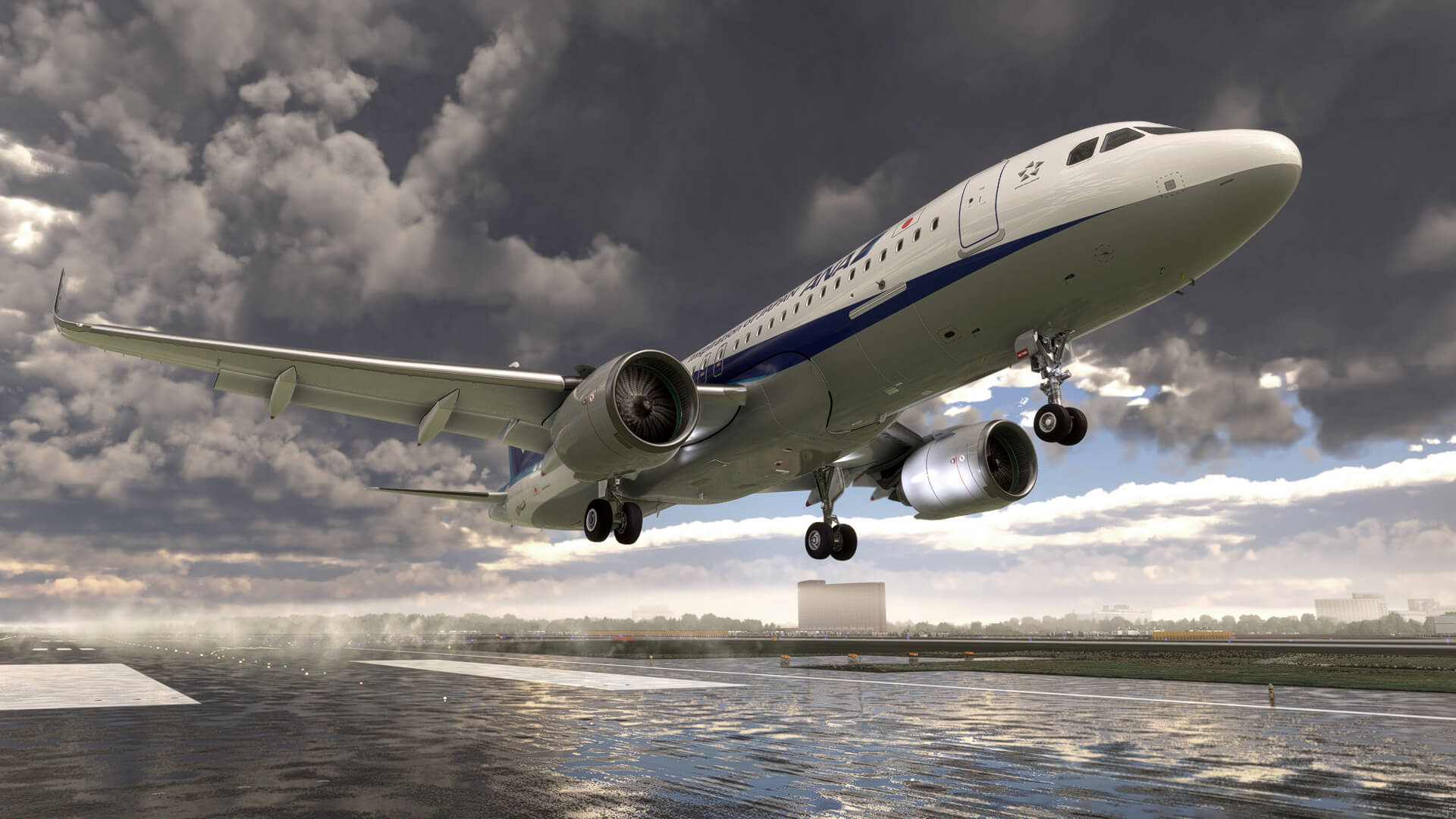 The Airbus A320 NEO in ANA paint scheme in the flare just before touching down on a wet runway, with water spraying up from the tarmac below