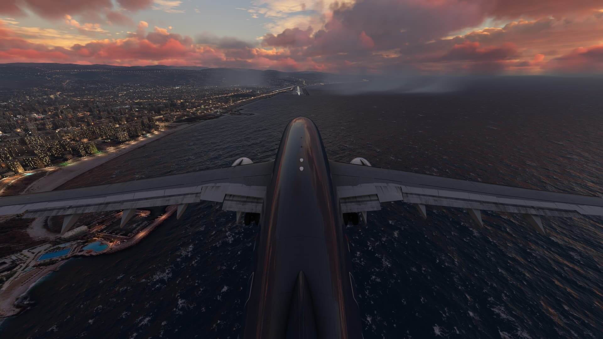 The view from the tail of an Airbus A310 with flaps and landing gear down on approach to an airport over water