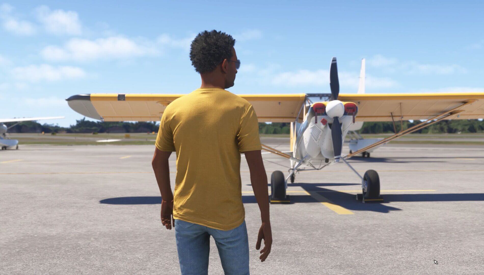 A pilot walks toward a CubCrafters XCub