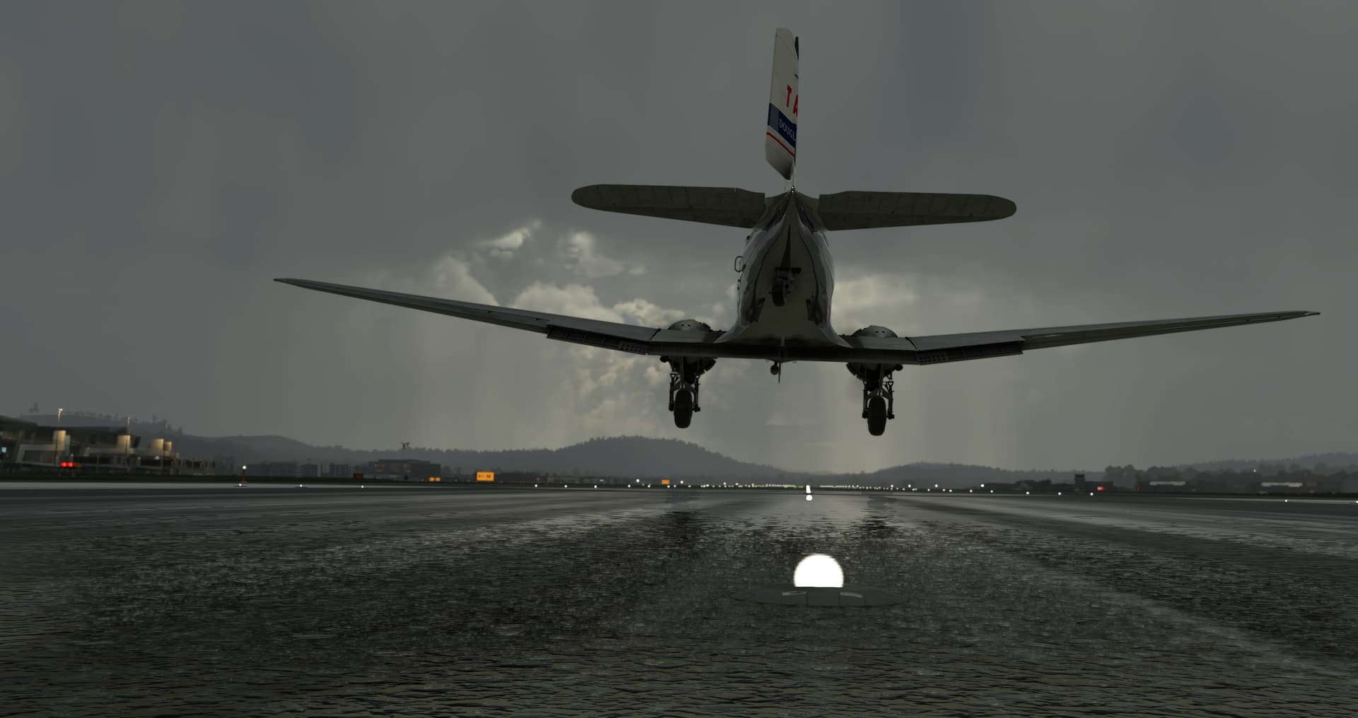 A view from behind a DC-3, with rudder deflecting to the left to maintain centreline before landing