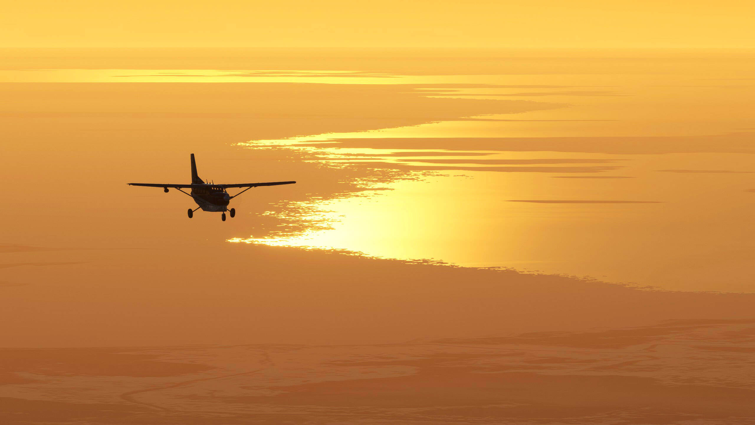 A Cessna cruises high above a snowy shoreline during golden hour