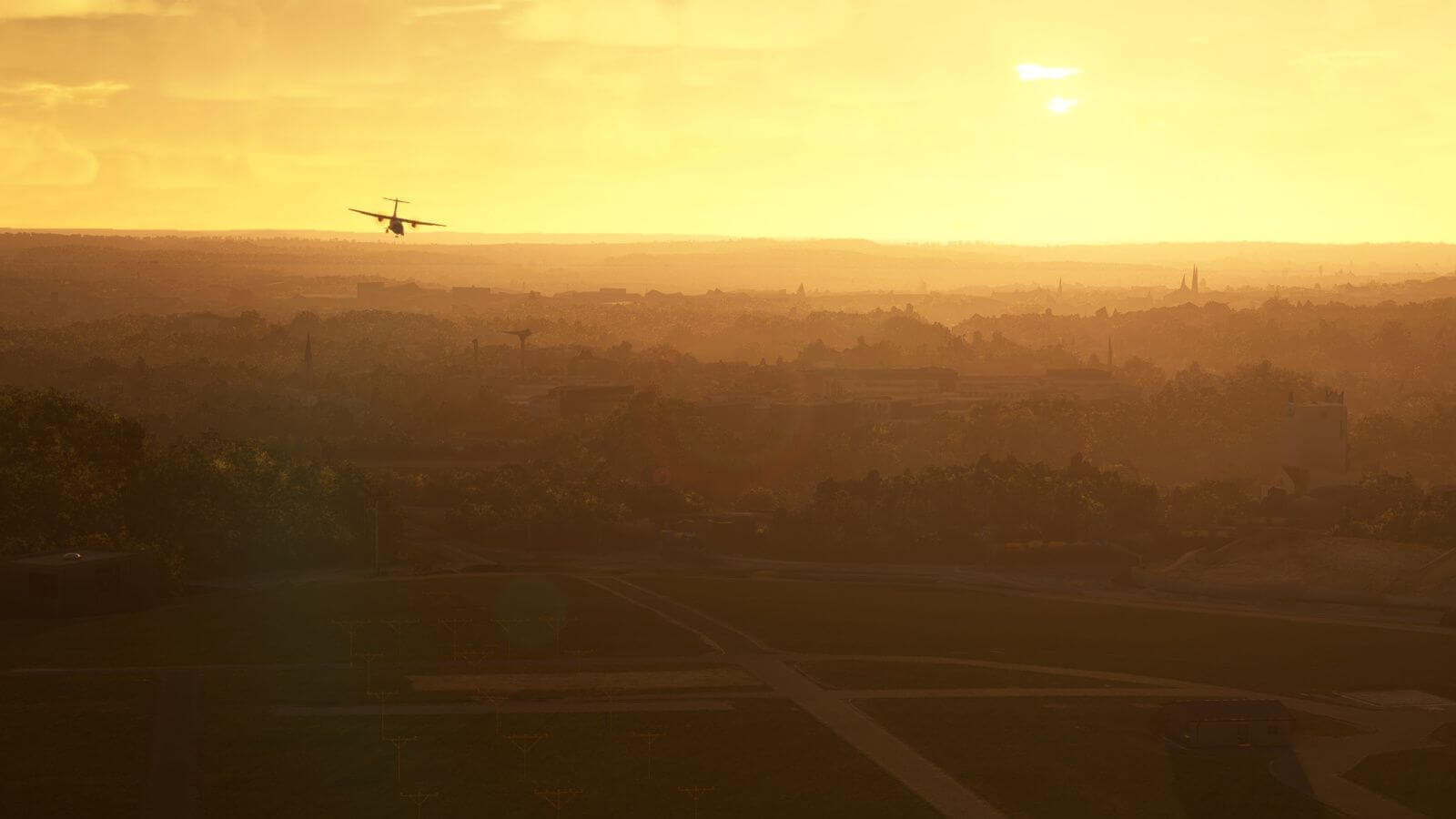 The silhouette of an ATR flying above a town during golden hour