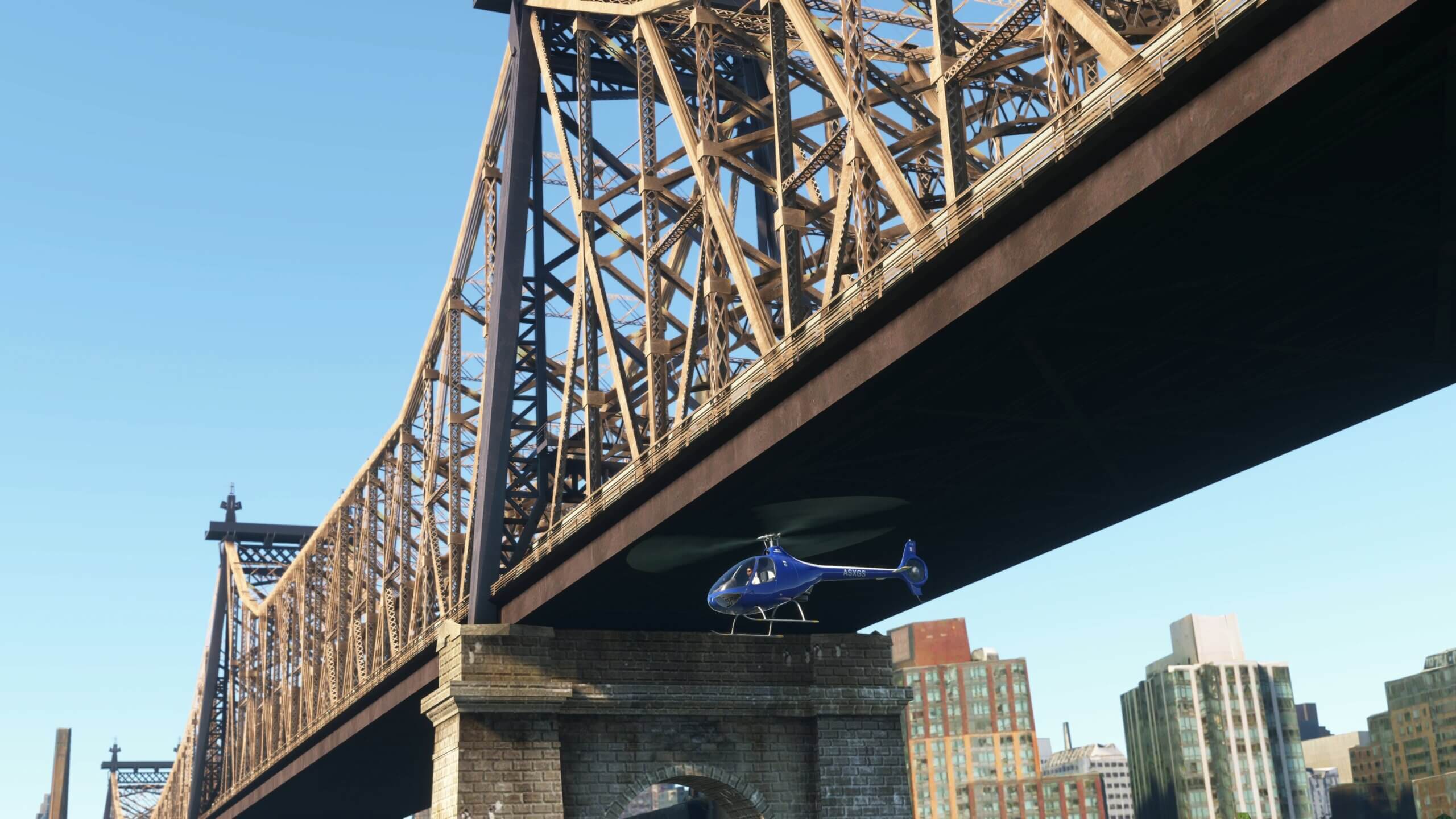 A G2 Cabri helicopter passes under a bridge