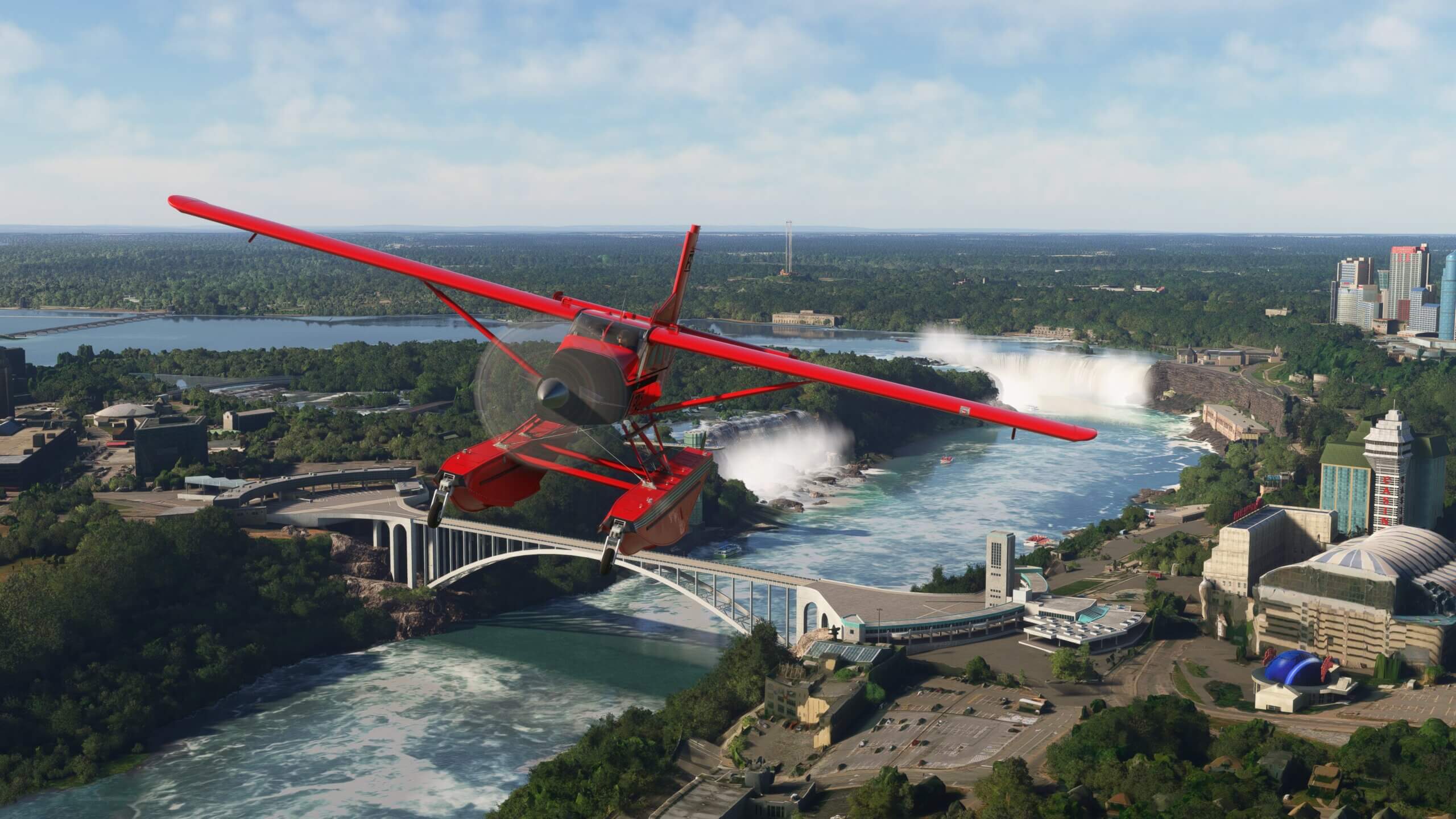 A red Pilatus PC-6 Porter passes over the Niagara Falls