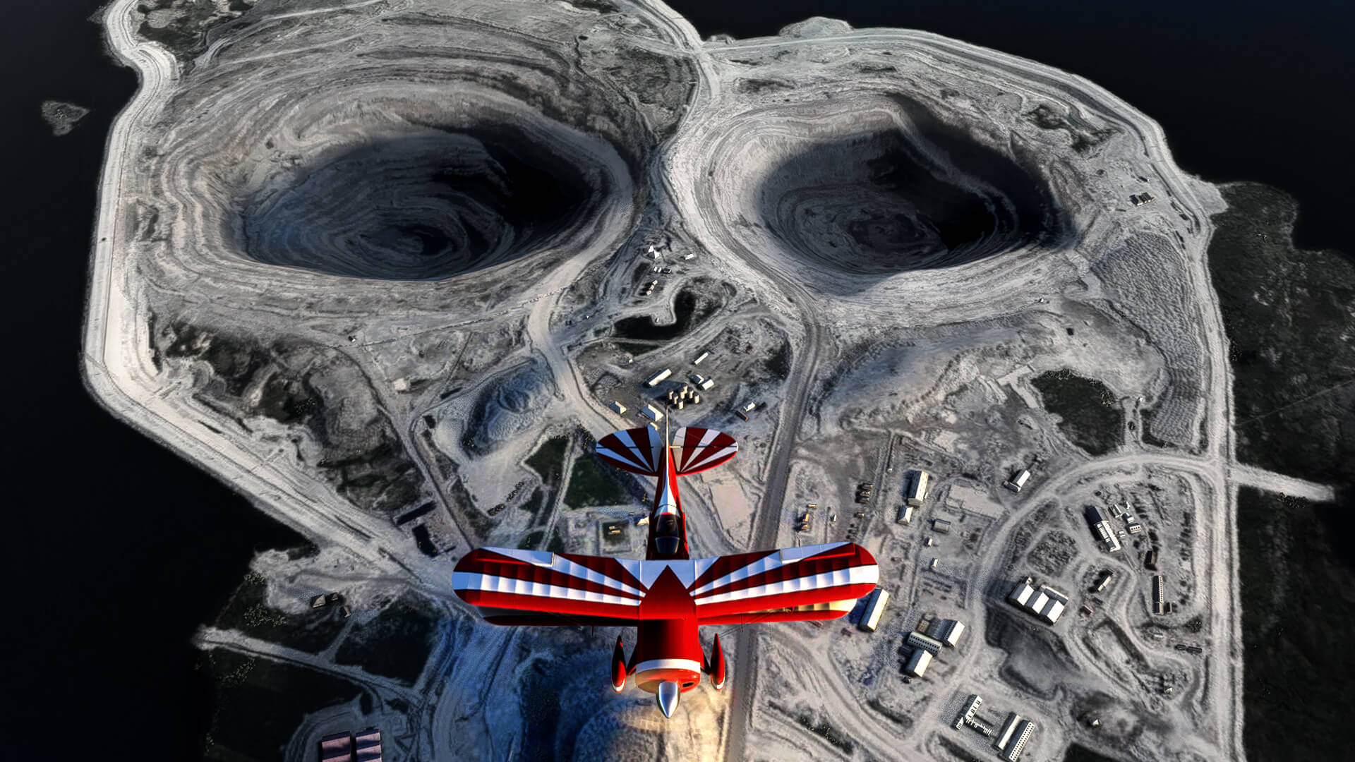 A dual wing red propeller aircraft flies over a mine that resembles a skull