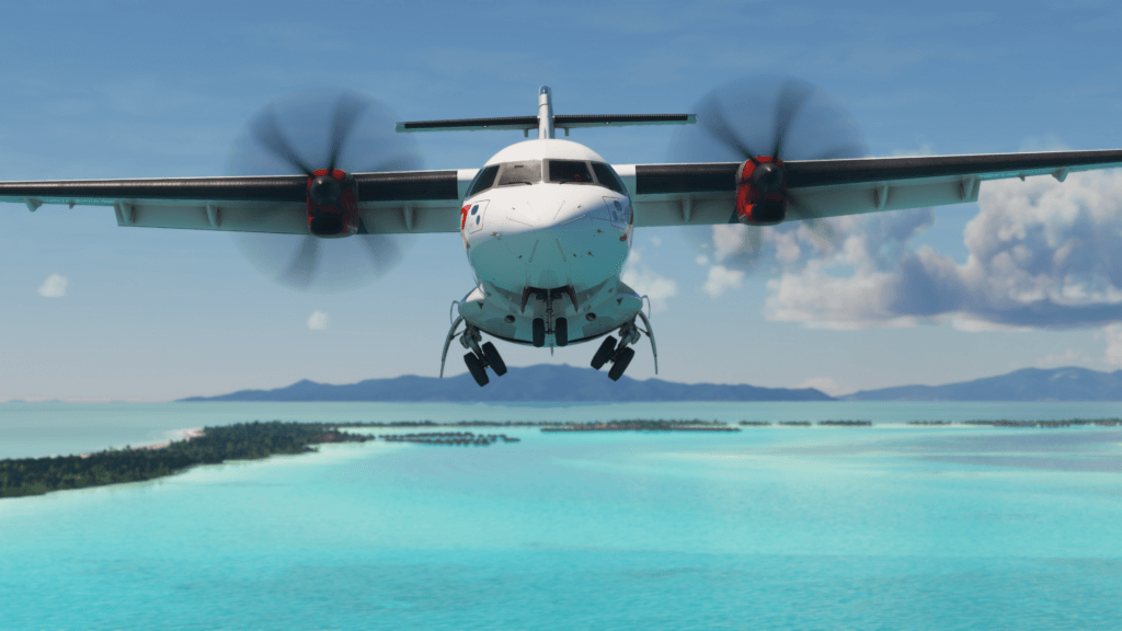 A front-on view of an ATR flying over a tropic island.