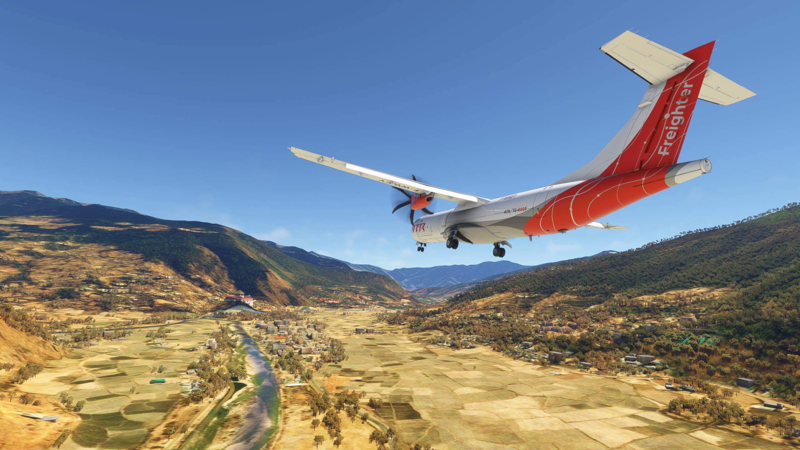 An ATR Freighter makes an approach through a valley