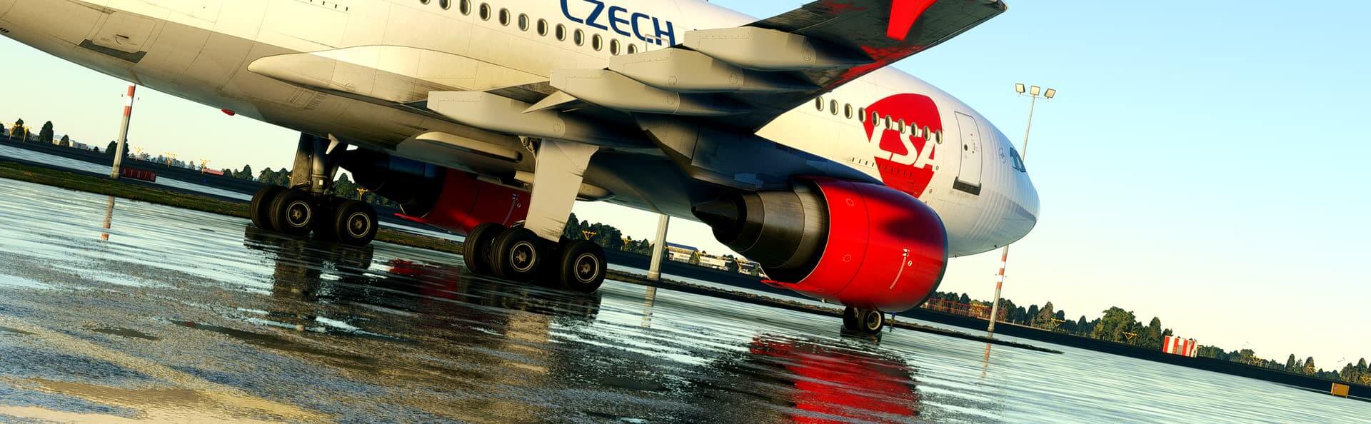 A Czech Airbus A310 sits idle on a wet airport apron