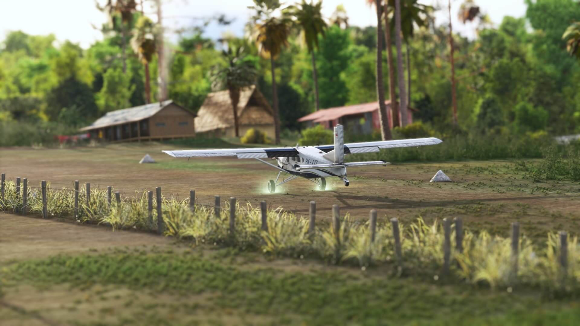 A Pilatus PC-6 Porter touching down on a dirt strip runway