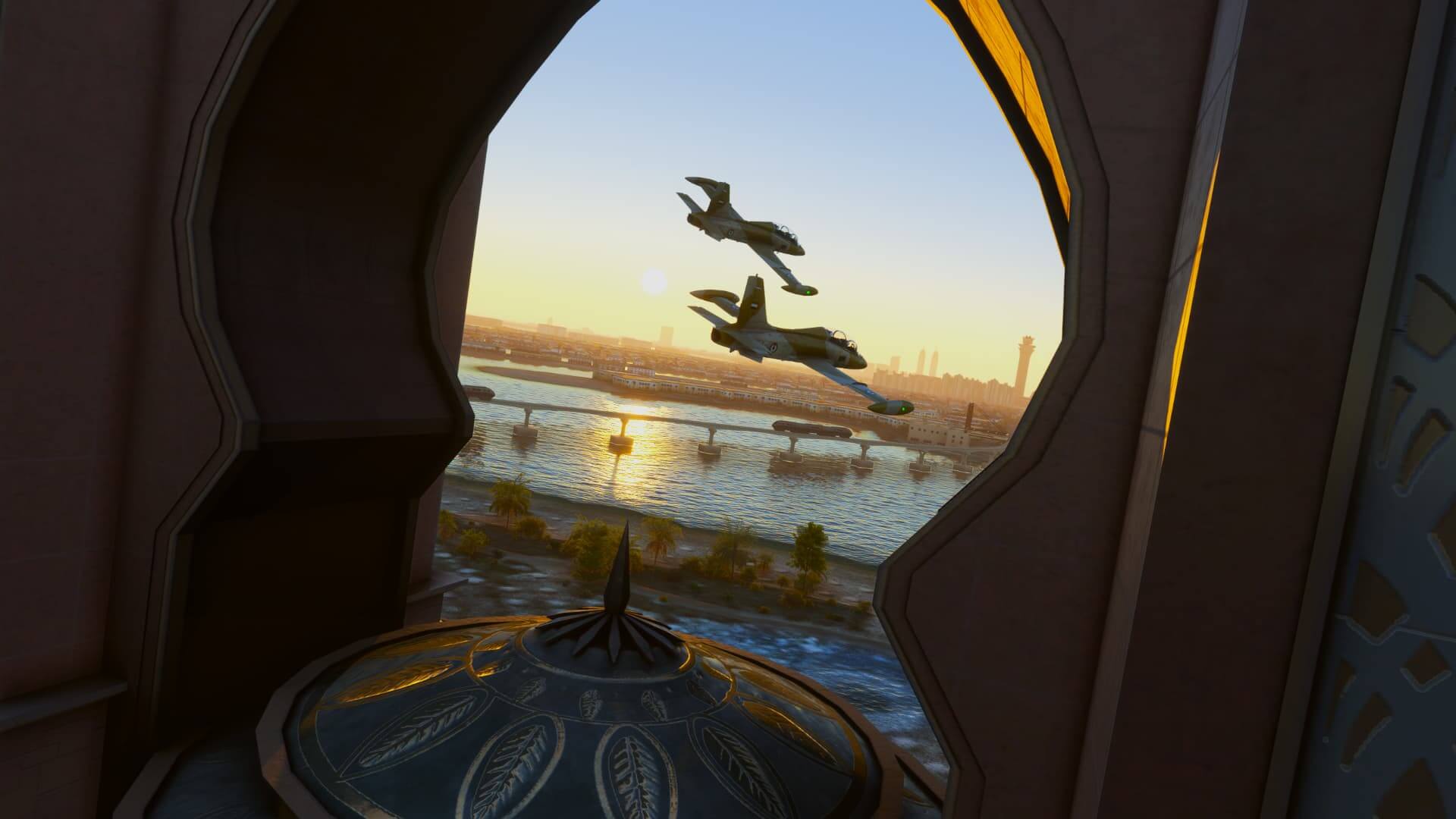 Two fighter jets fly in close formation between a monument with the sun in the distance