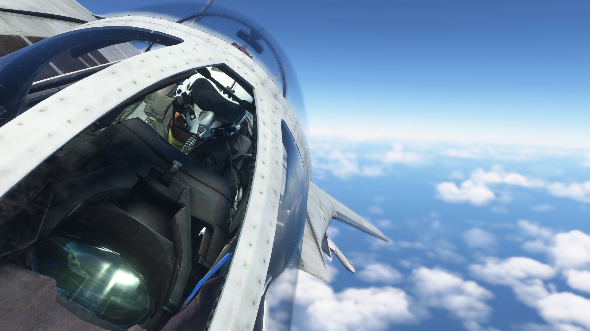 A view looking into the cockpit of an F-14 Tomcat as it banks left over water