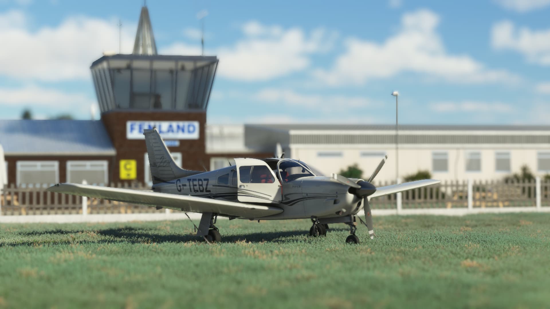 A Piper Archer parked on a grassy field.