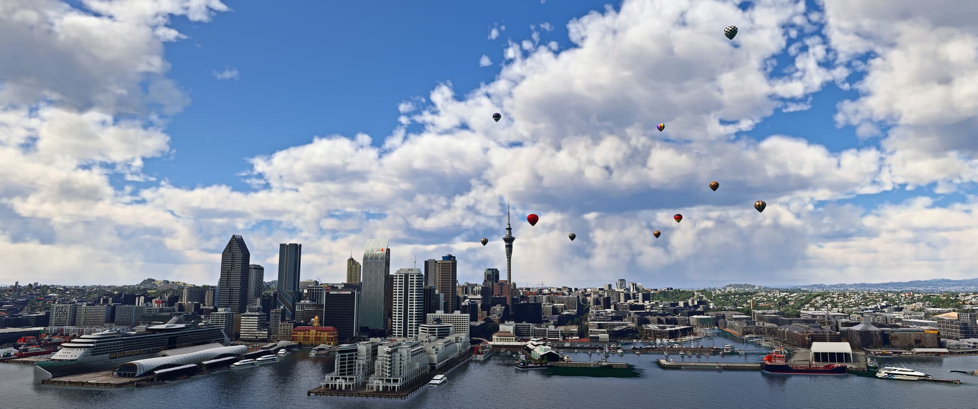 A number of hot air balloons can be seen in flight above a city