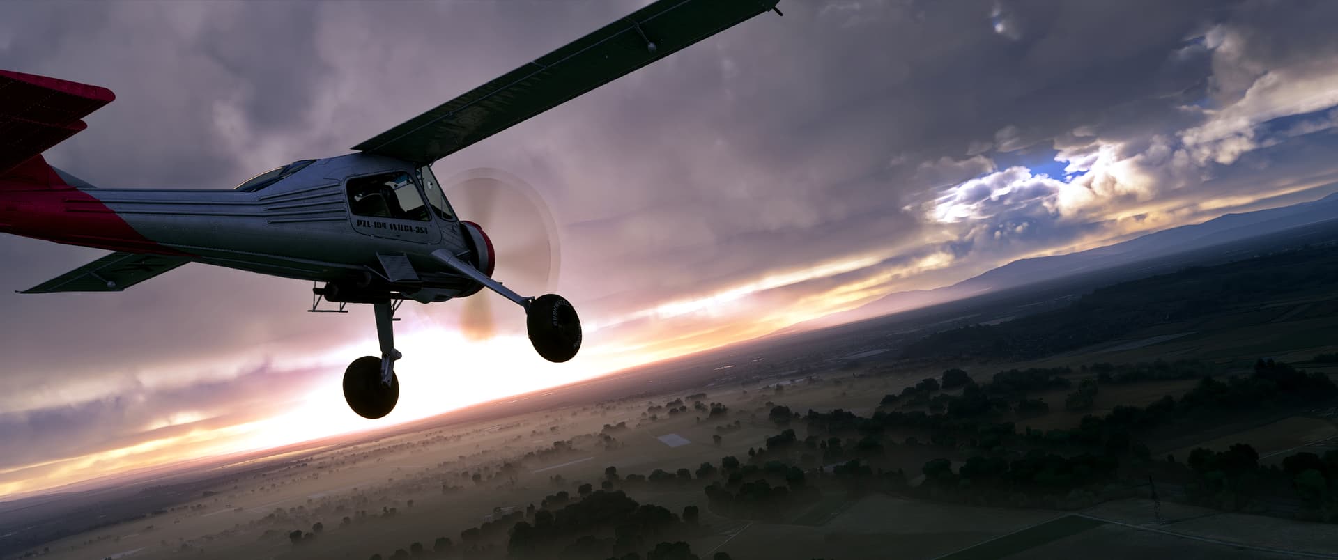 A small high-wing propeller aircraft flies above misty fields