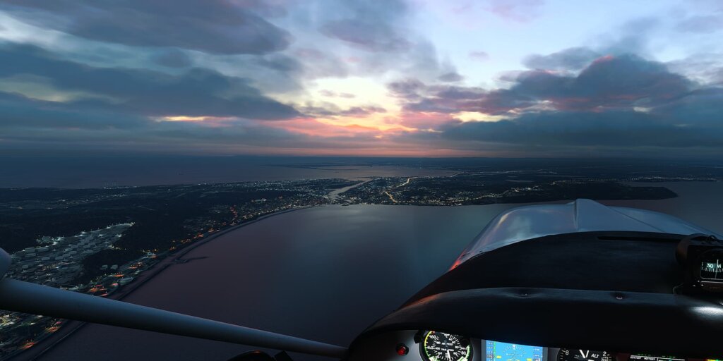 A general aviation aircraft cruises during a sunset