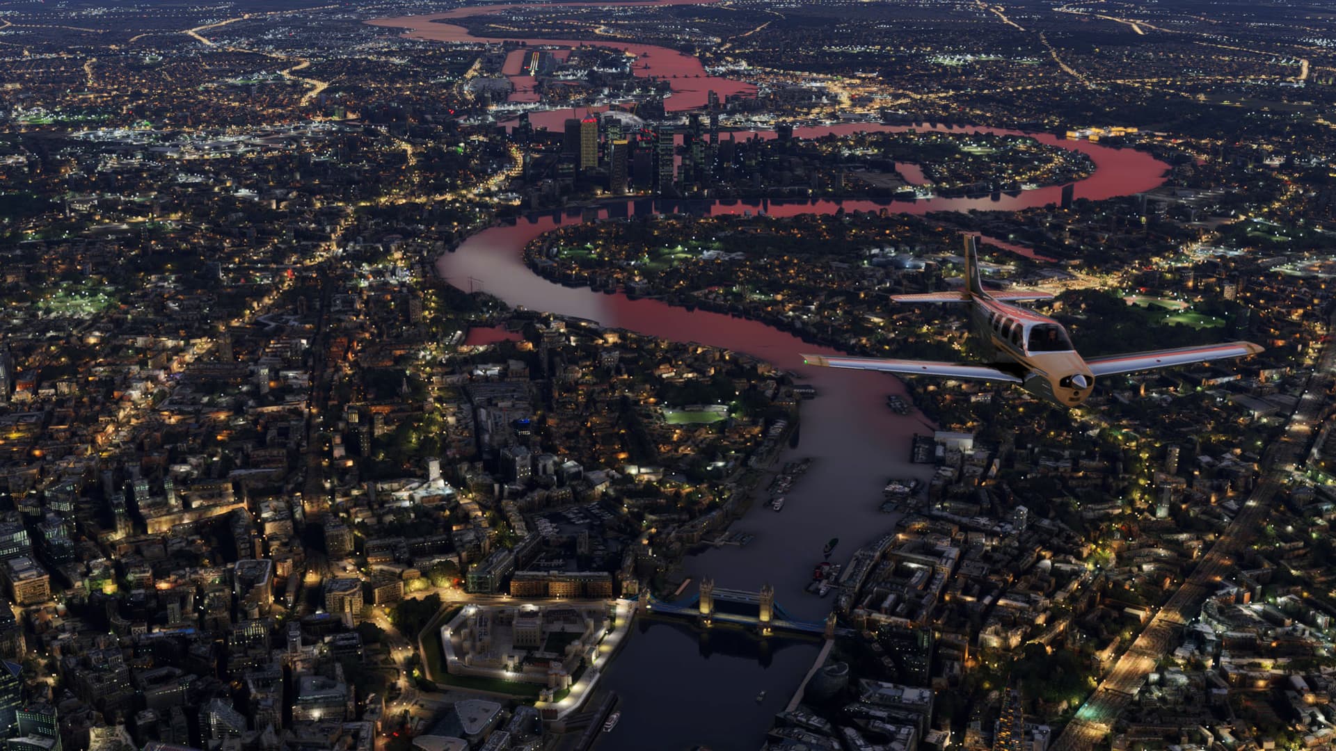 A low wing propeller aircraft flies over the city of London