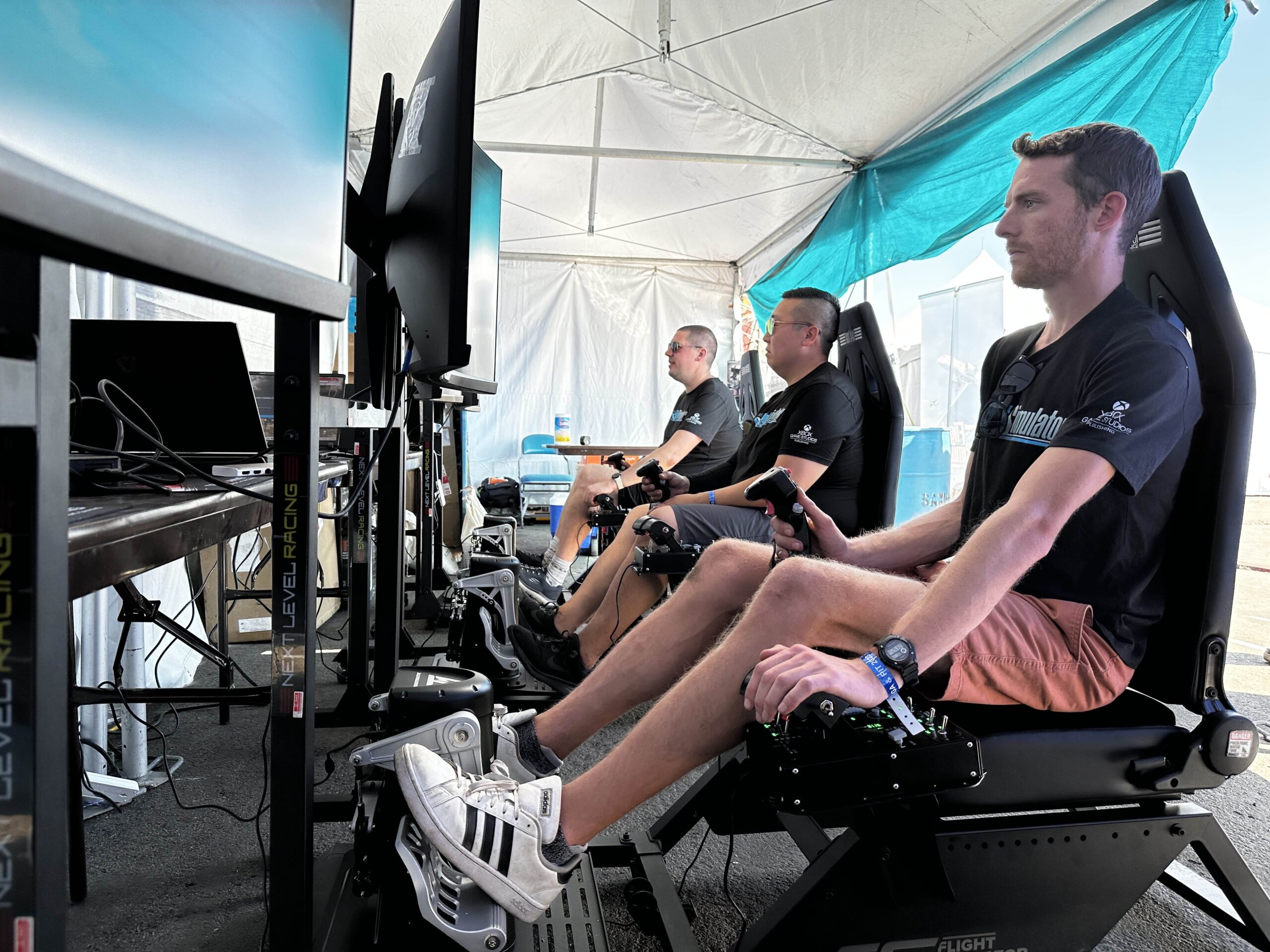 Members of the Microsoft Flight Simulator team demo Next Level Racing setups at the Reno Air Races in 2023