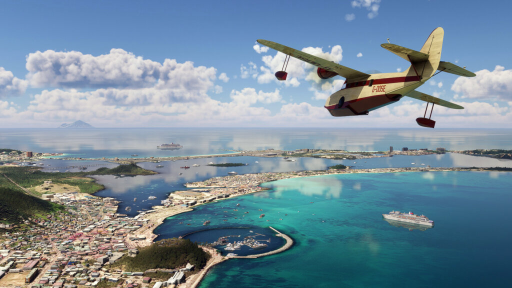 A Grumman Goose flies over a tropical seaside town.