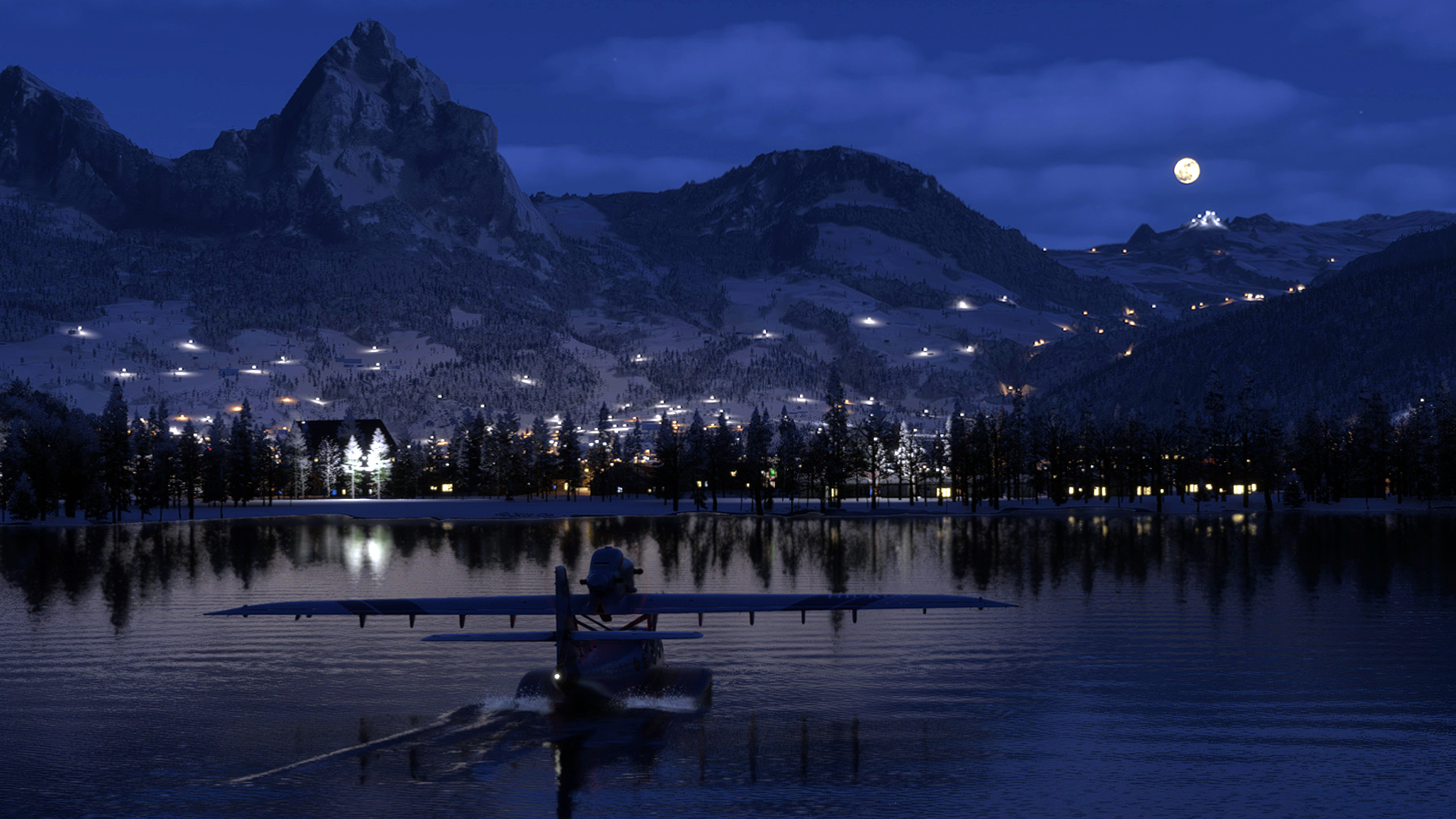 A water float aircraft moves across the water towards the edge of a lake at night