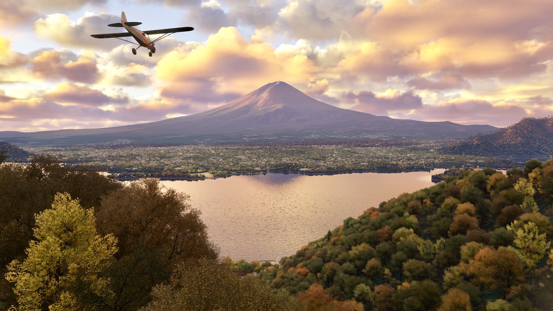 An X-Cub flies towards a volcano above an Autumn landscape