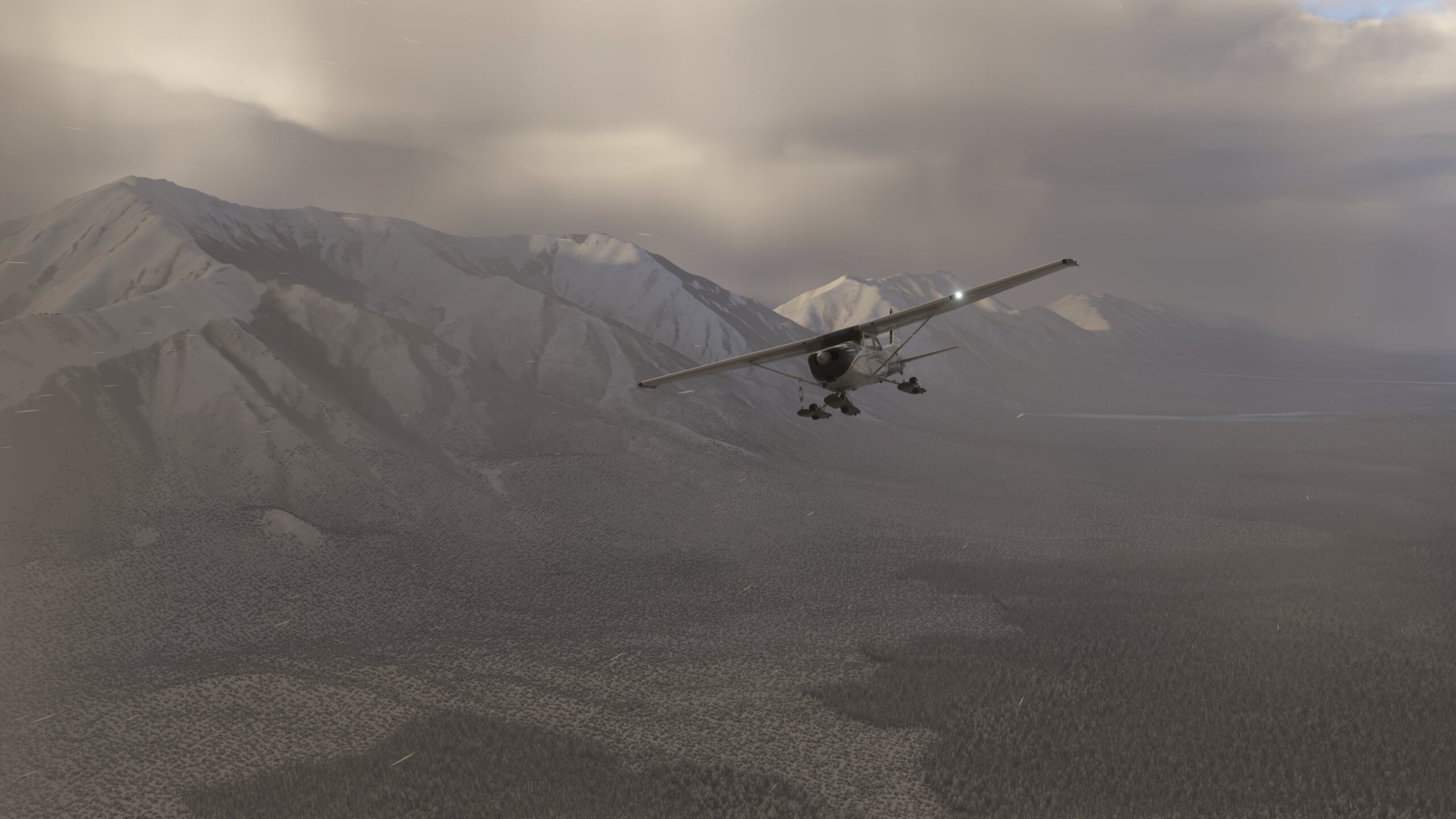 A Cessna 172 flies through a snowy mountain range valley