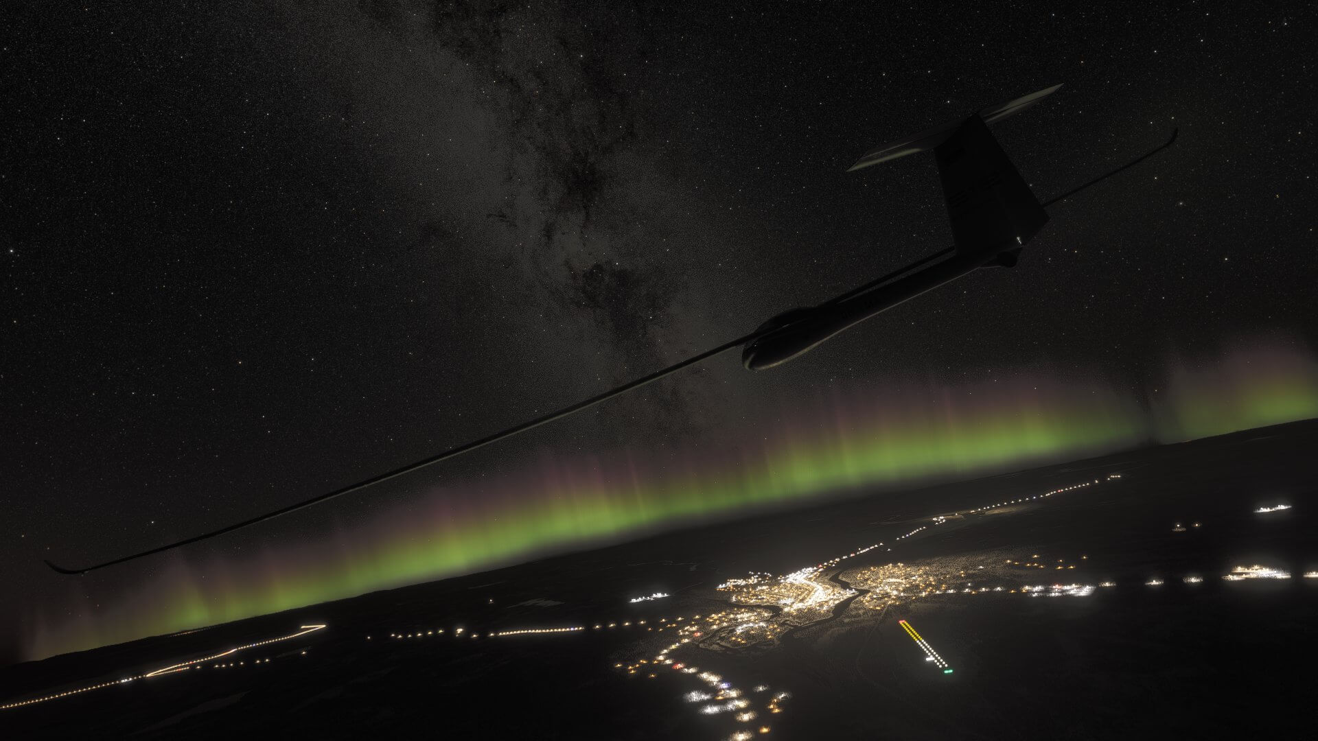 A glider flying above an airport at night, with the aurora borealis and milky way in the sky