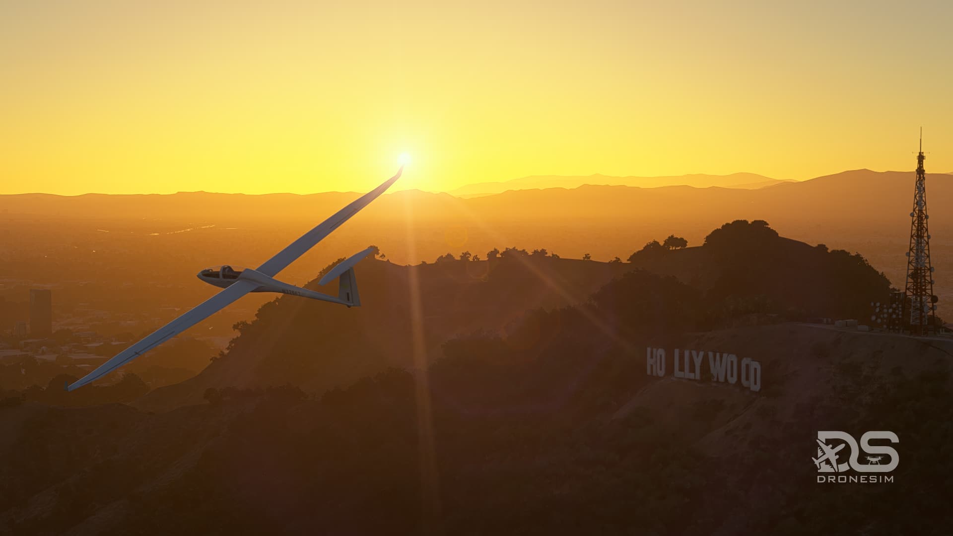 A glider banks left next to the Hollywood sign in Los Angeles during golden hour