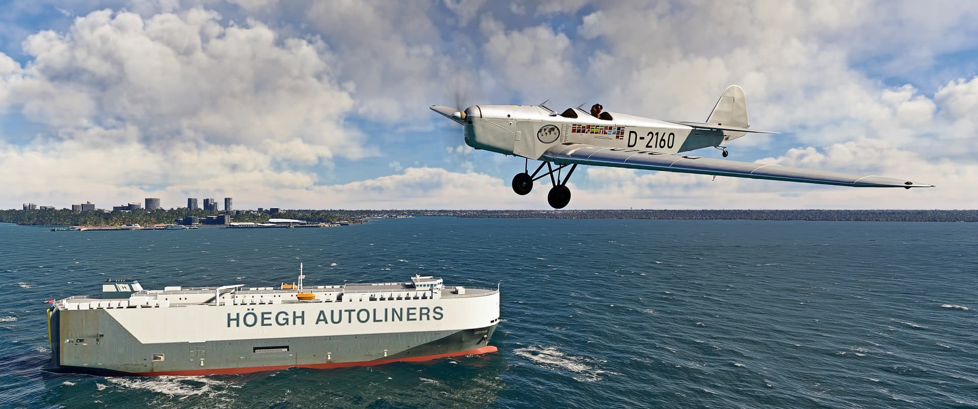 A low wing prop aircraft flies over a passing boat in similar white colour scheme